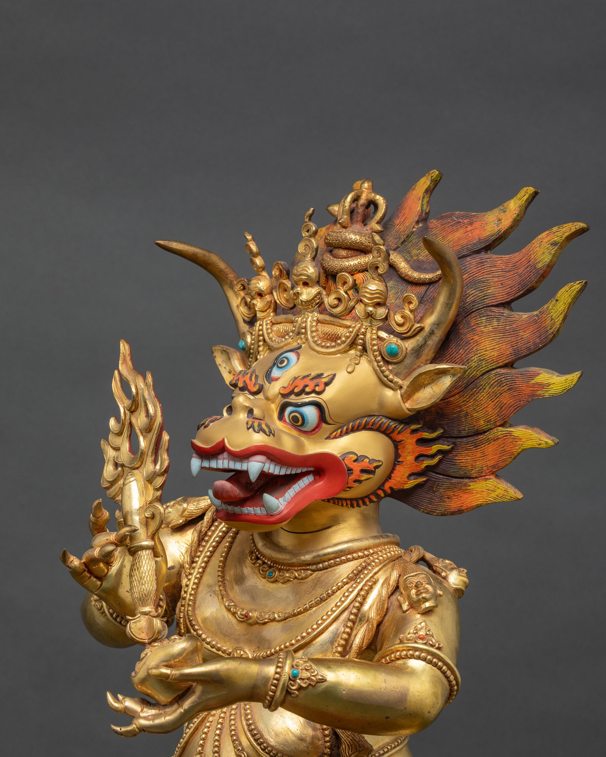 Side close-up of Yamantaka statue showing intricate carvings and flaming halo