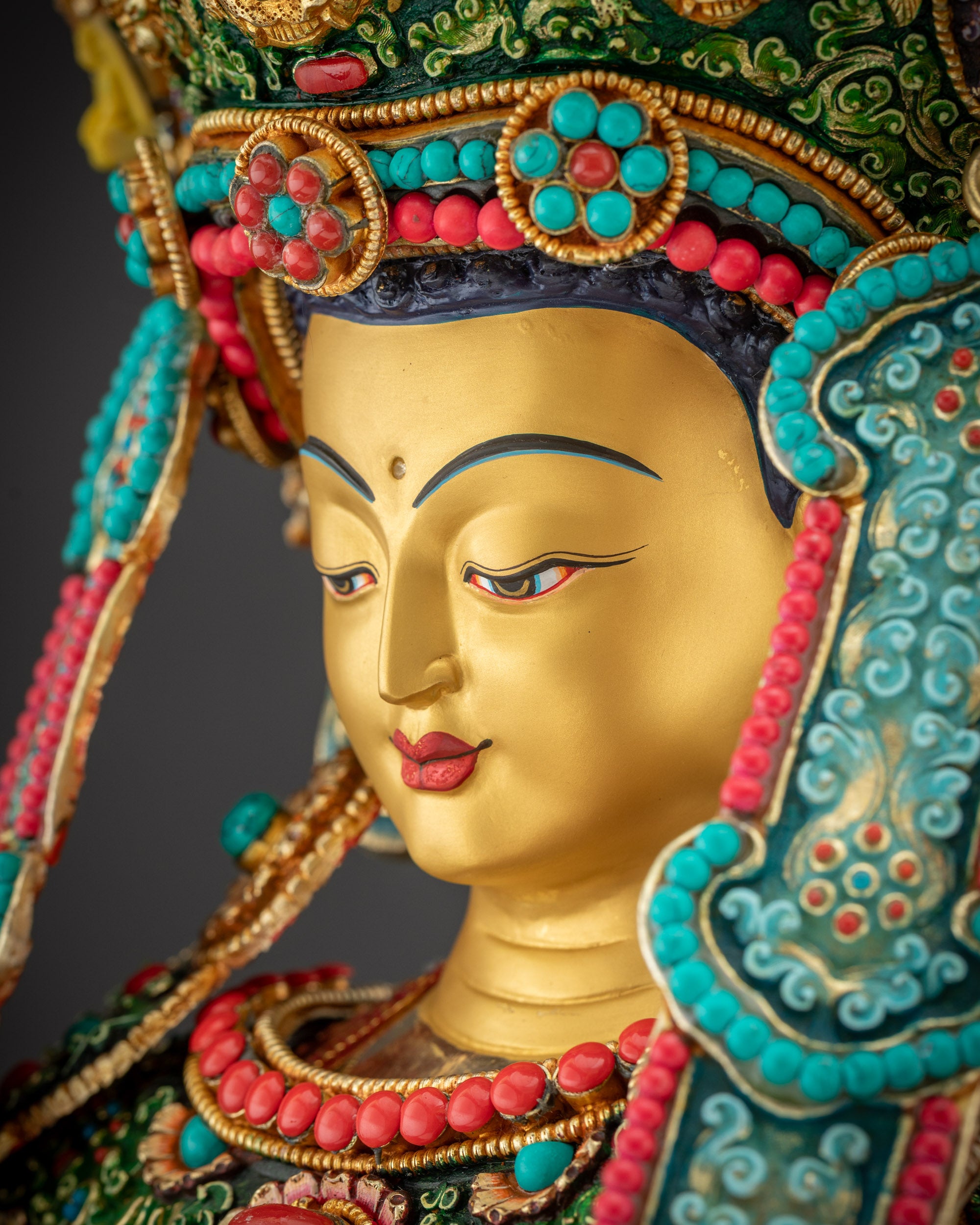 Side close up face Jowo Rinpoche Shakyamuni statue with intricate earrings and crown