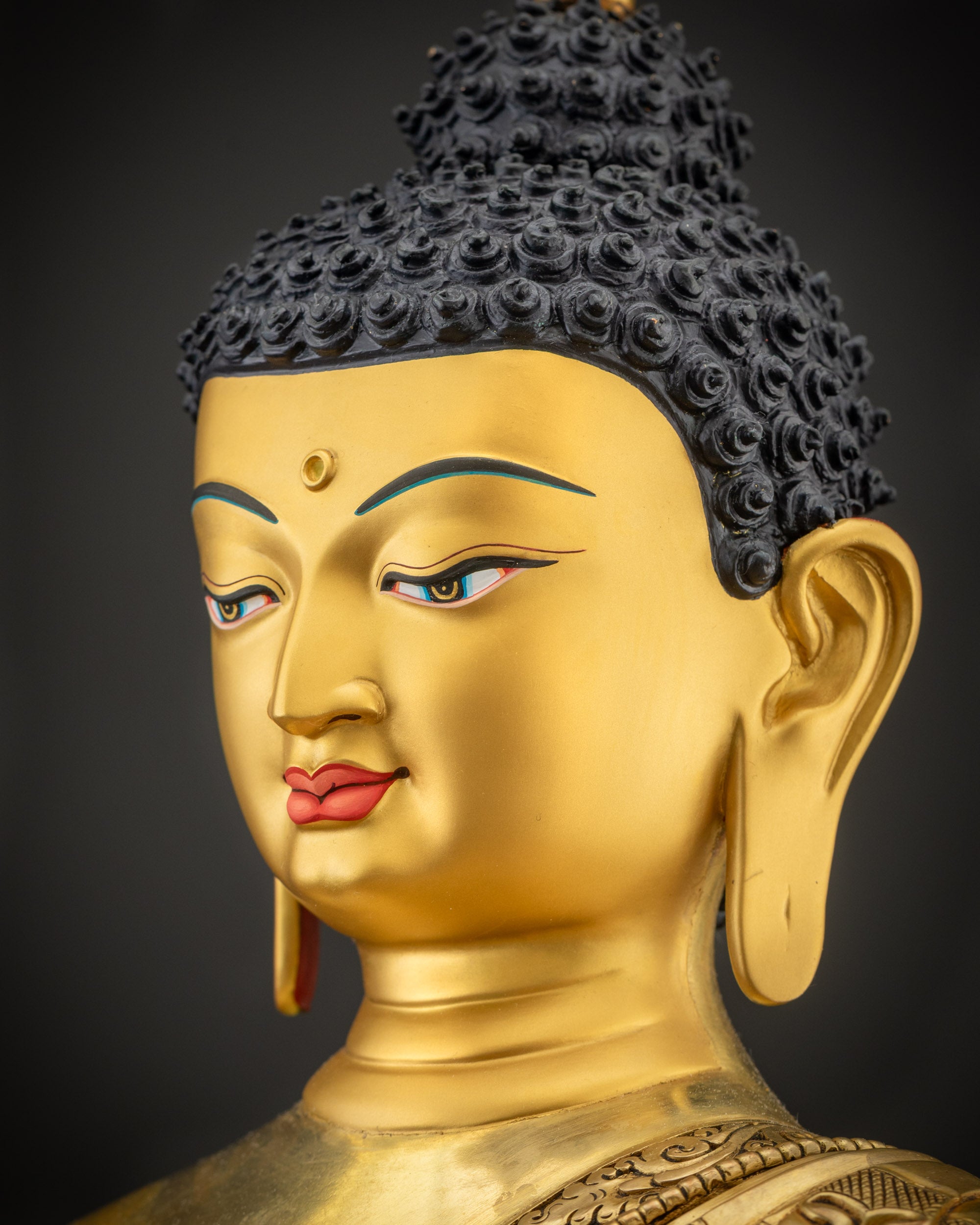 Side close up face of Amitabha Buddha Statue, serene expression and carved crown