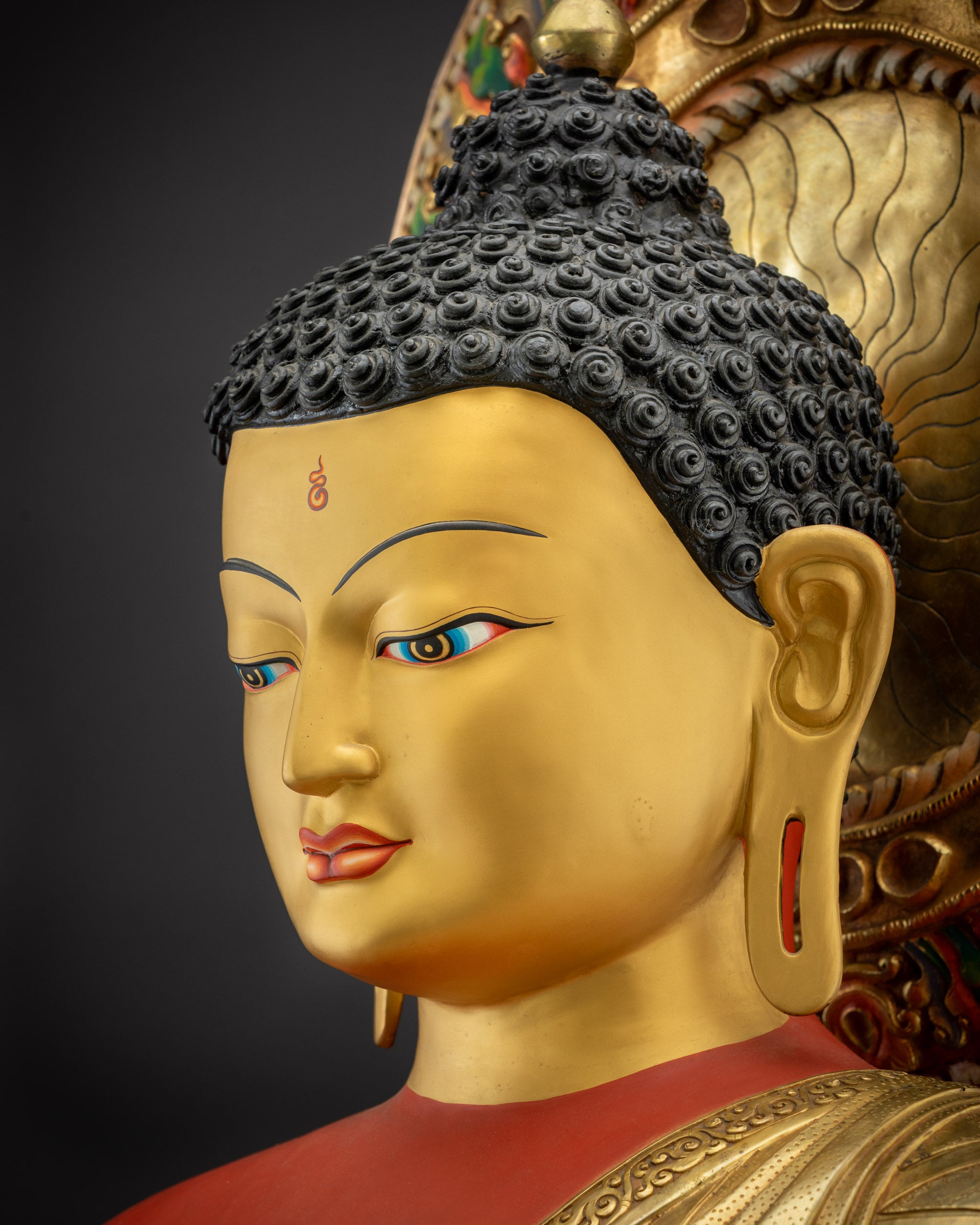 Side close up face of Amitabha Buddha showing peaceful expression and halo