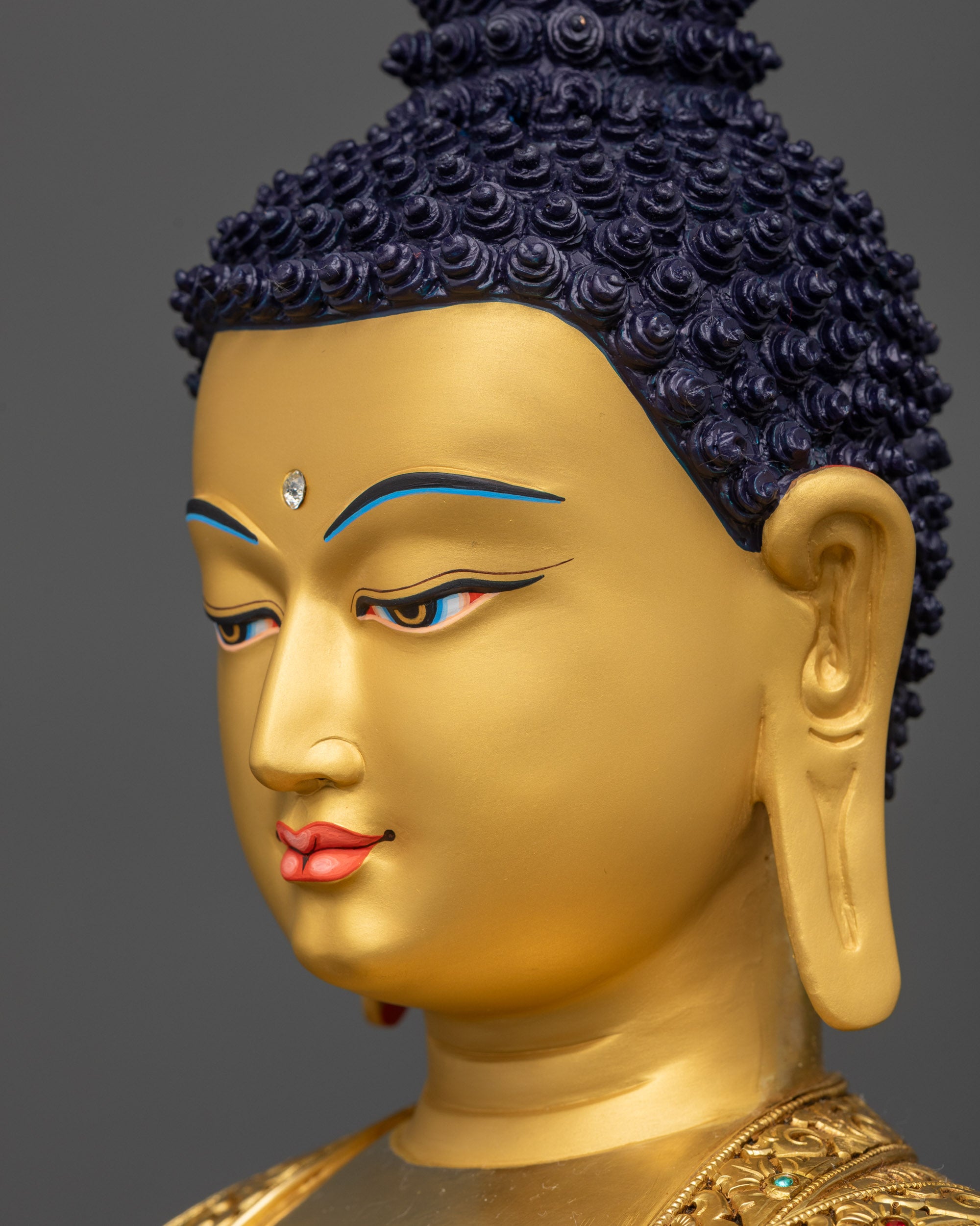 Side close up face of Gautama Buddha Sculpture with warm gold-gilded texture