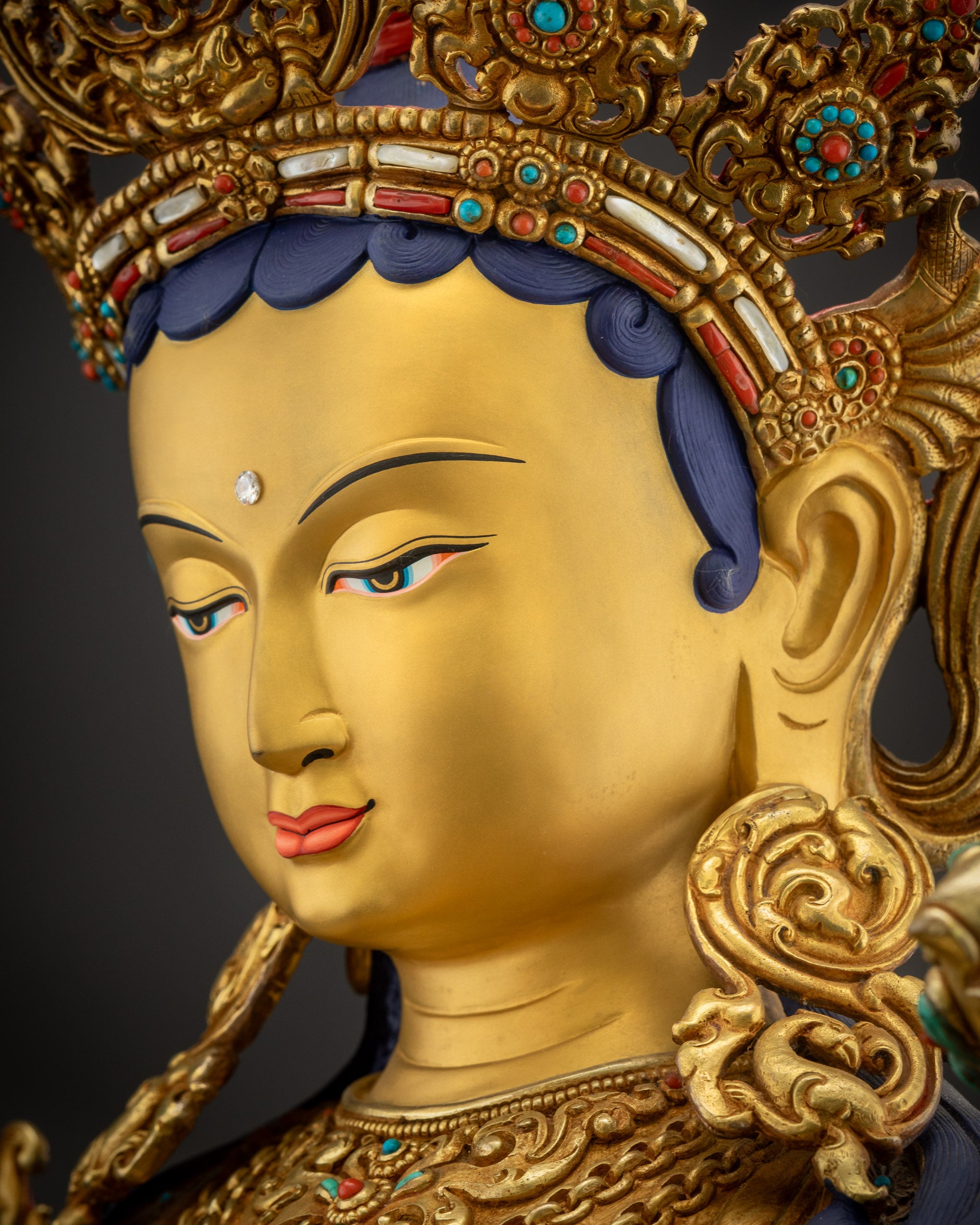 Side close up face of Green Tara meditation statue highlighting divine serene features