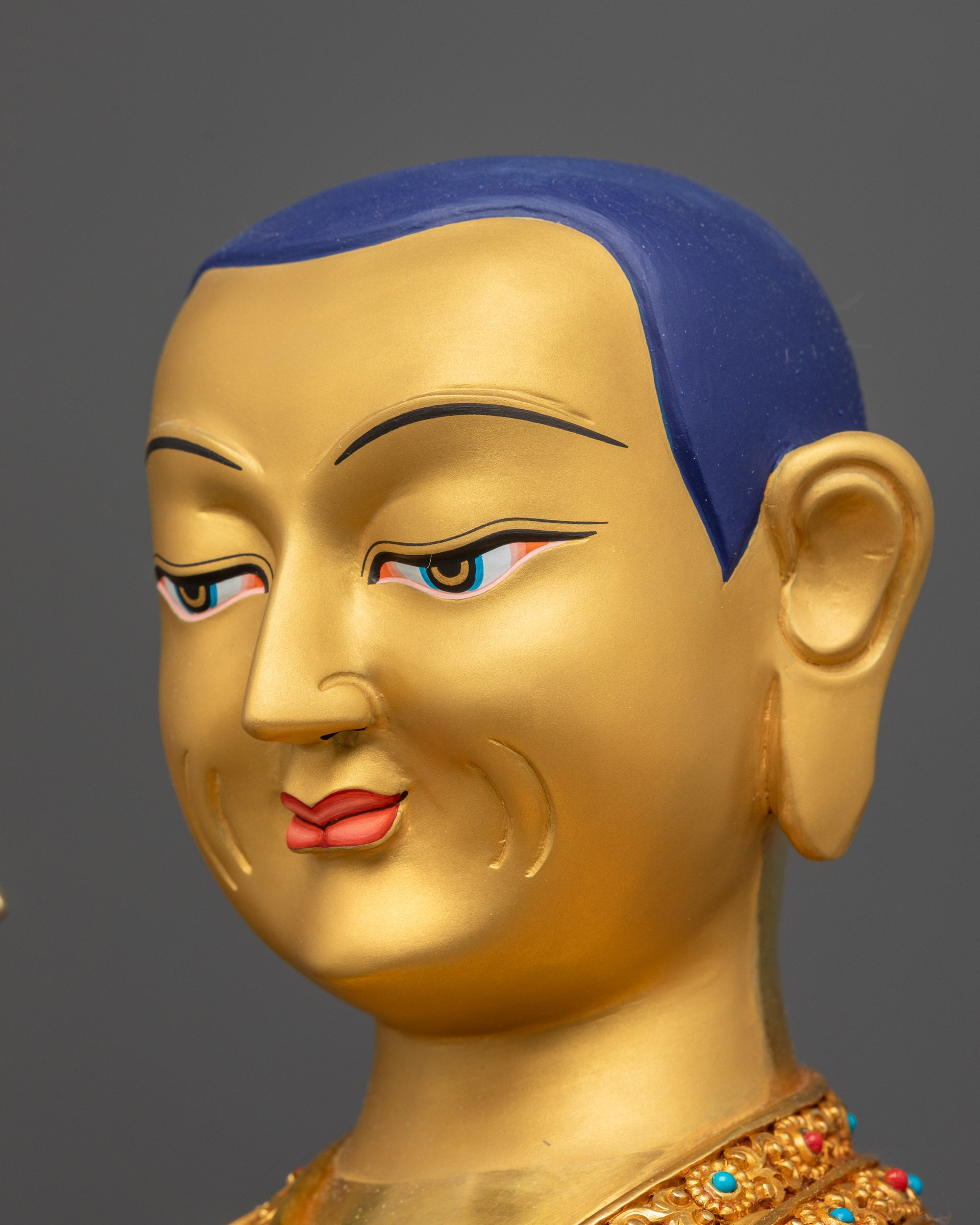 Side close up face of Je Tsongkhapa highlighting wisdom flame sword and sutra