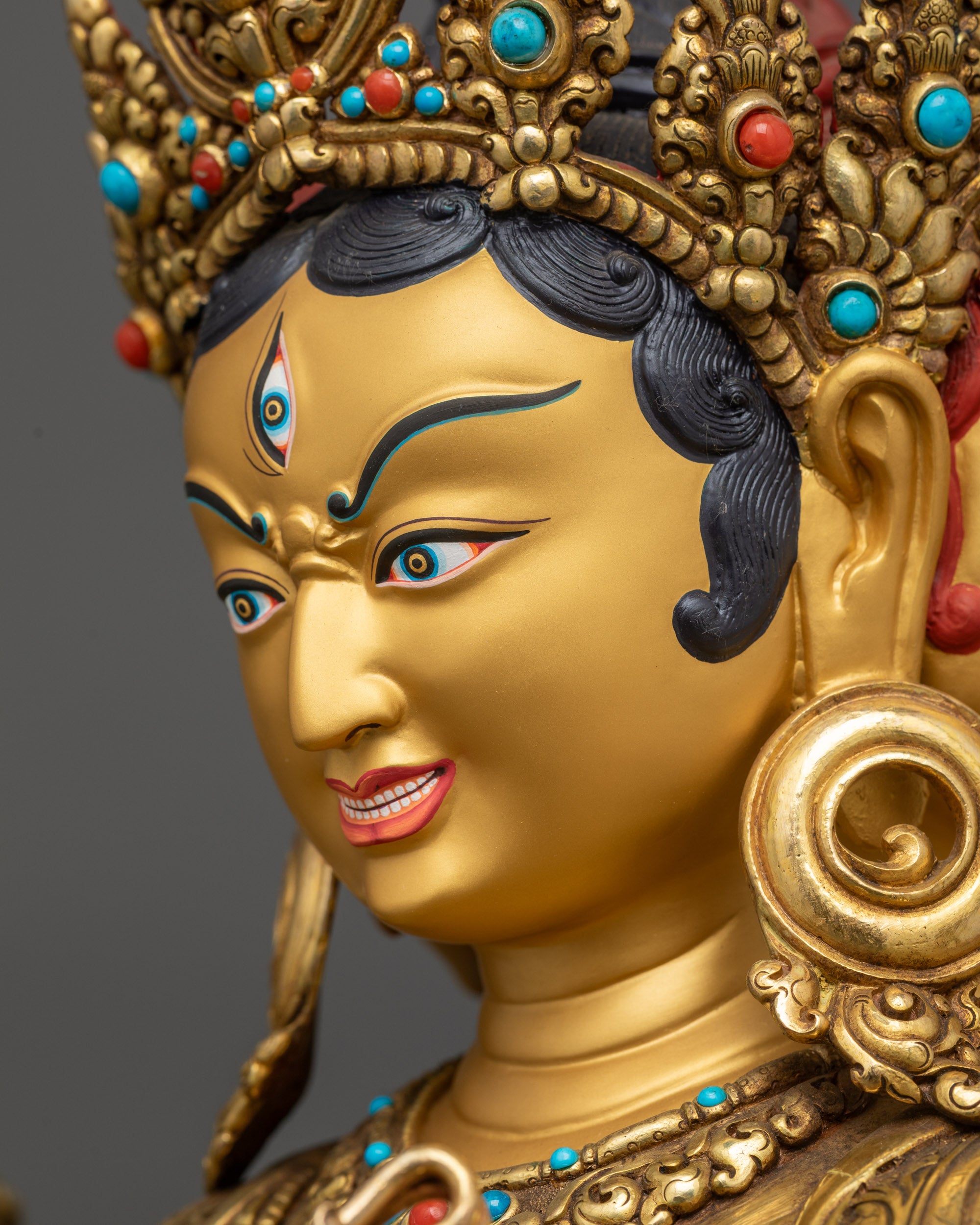 Side close up face of Namgyalma showing three heads and enlightened expression
