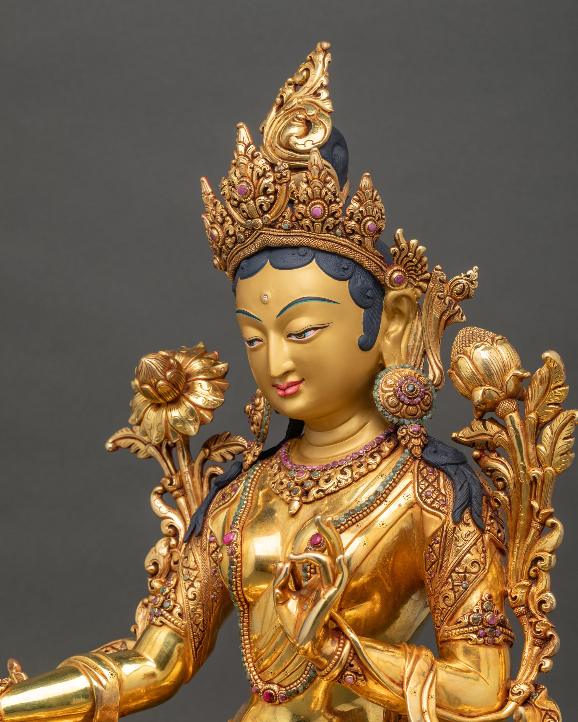 Side close up highlighting flowing robes and delicate 3D carvings on copper