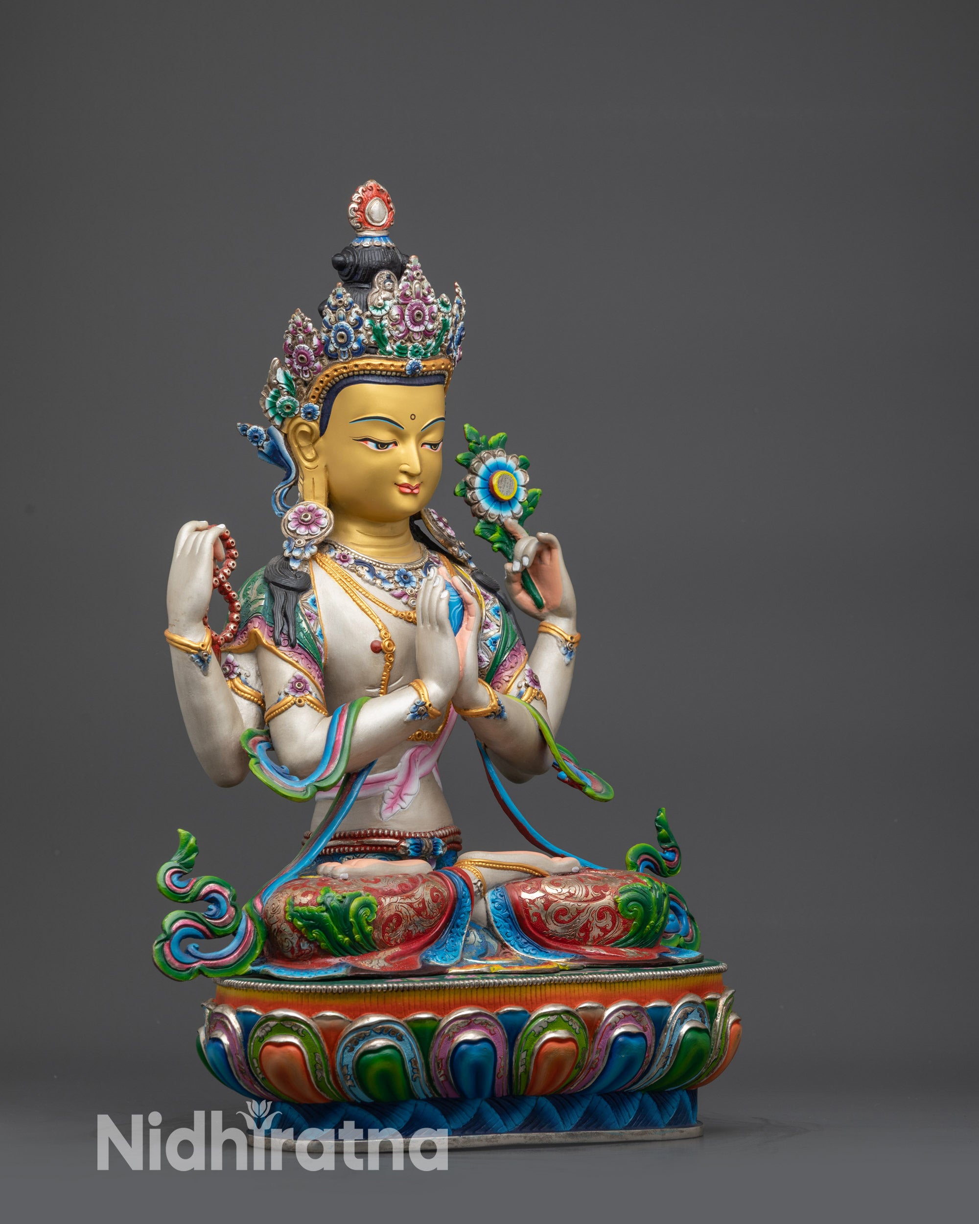 Side close up of Chenrezig gold-gilded face and lotus blossom in hand