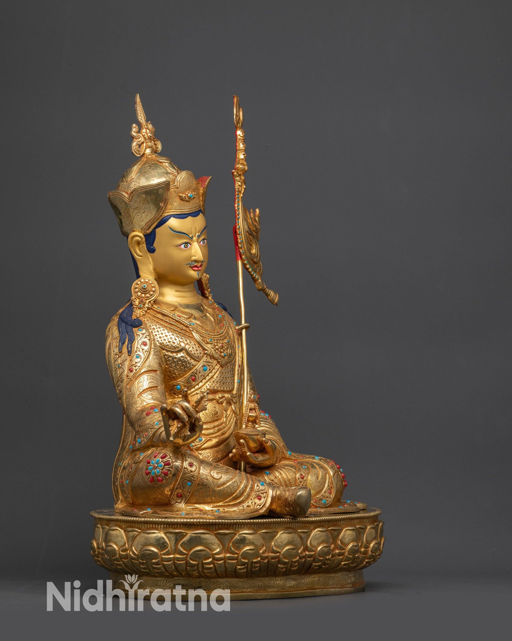 Side close up of Guru Rinpoche face with lotus hat and kasaya robe details