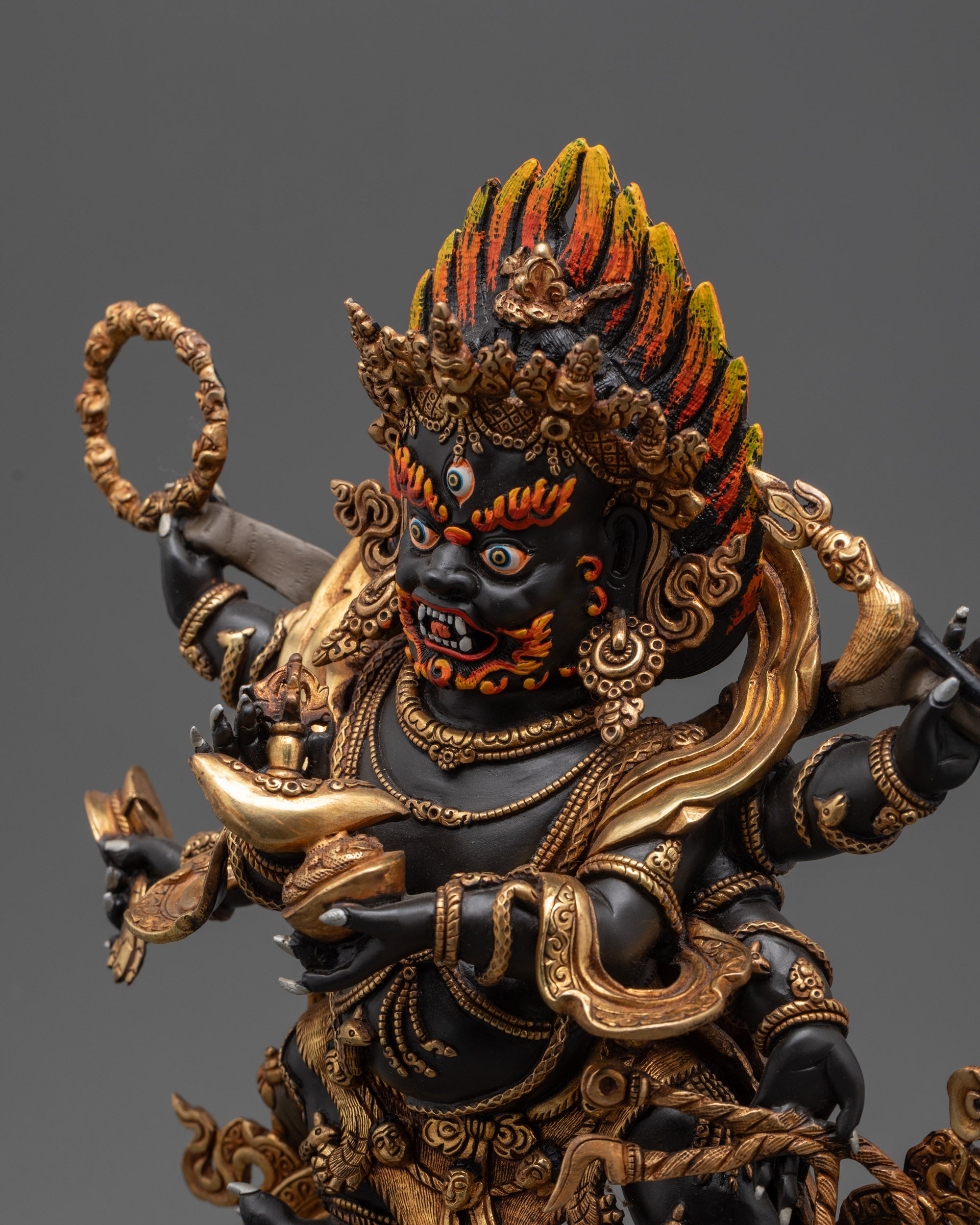 Side close up of gold-plated robe, tiger-skin garments, and intricate patterns