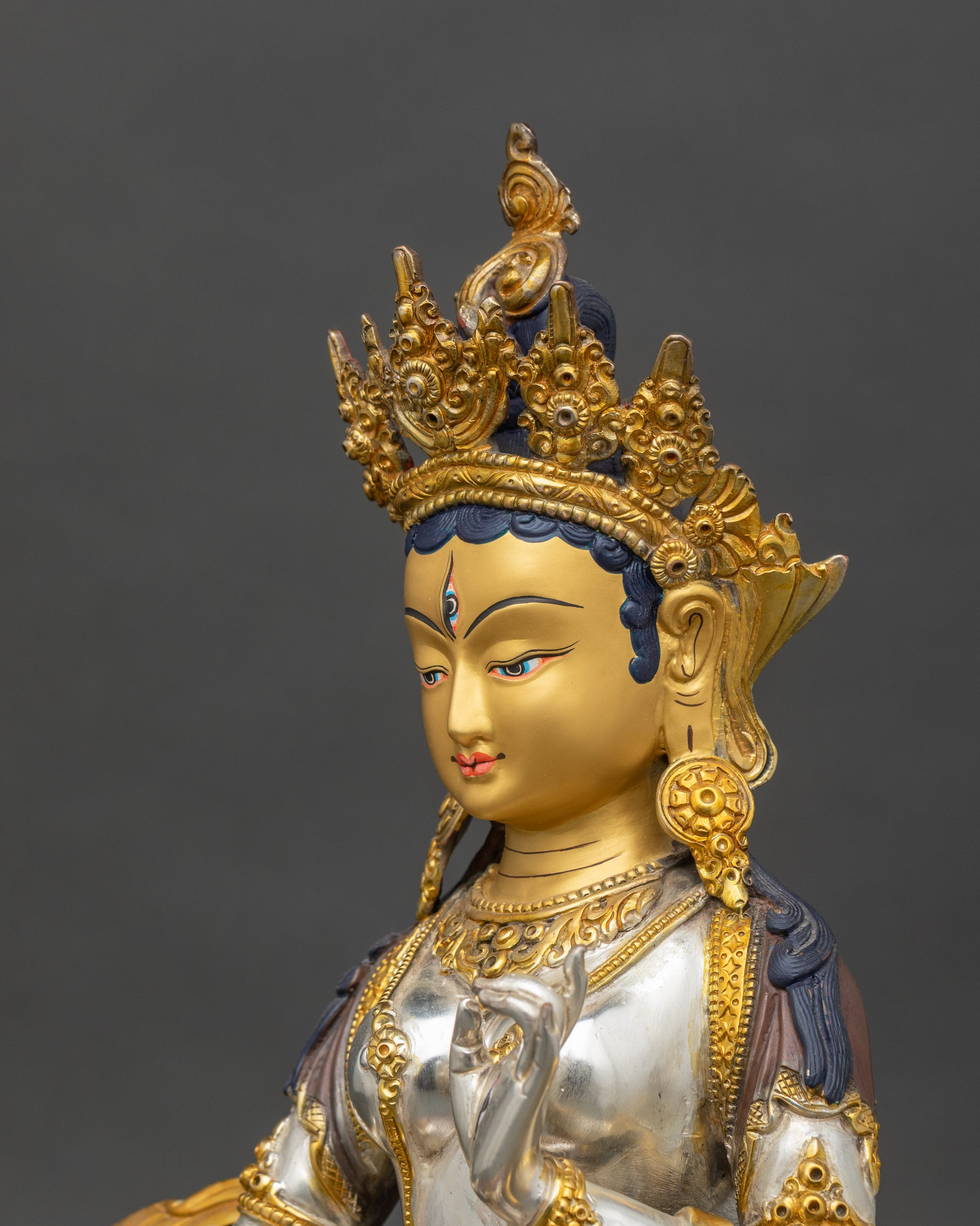 Side detail of Dukar Sitatapatra statue showing silver body and gold jewelry craftsmanship