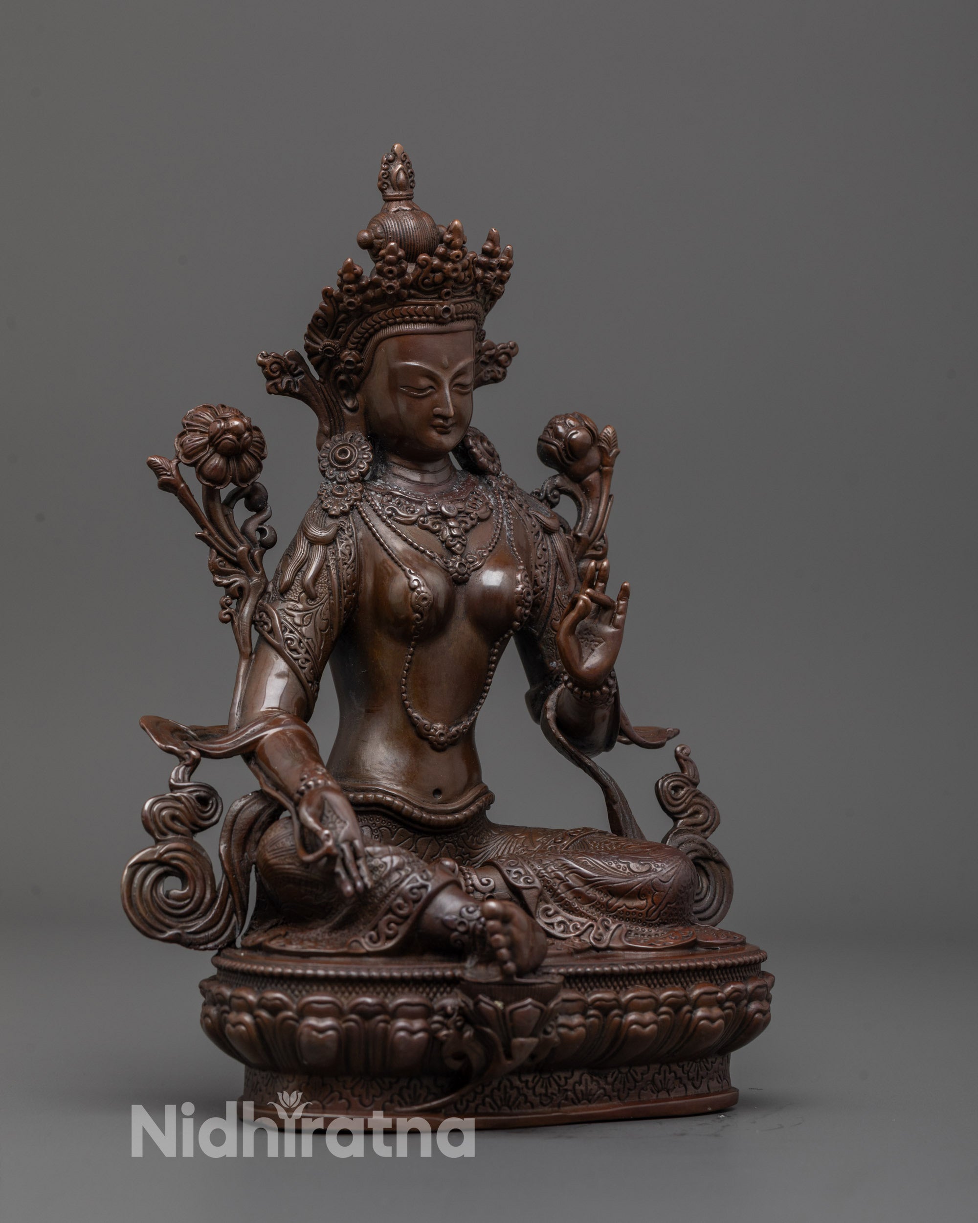 Side profile of Green Tara Sculpture showing elegant robe details