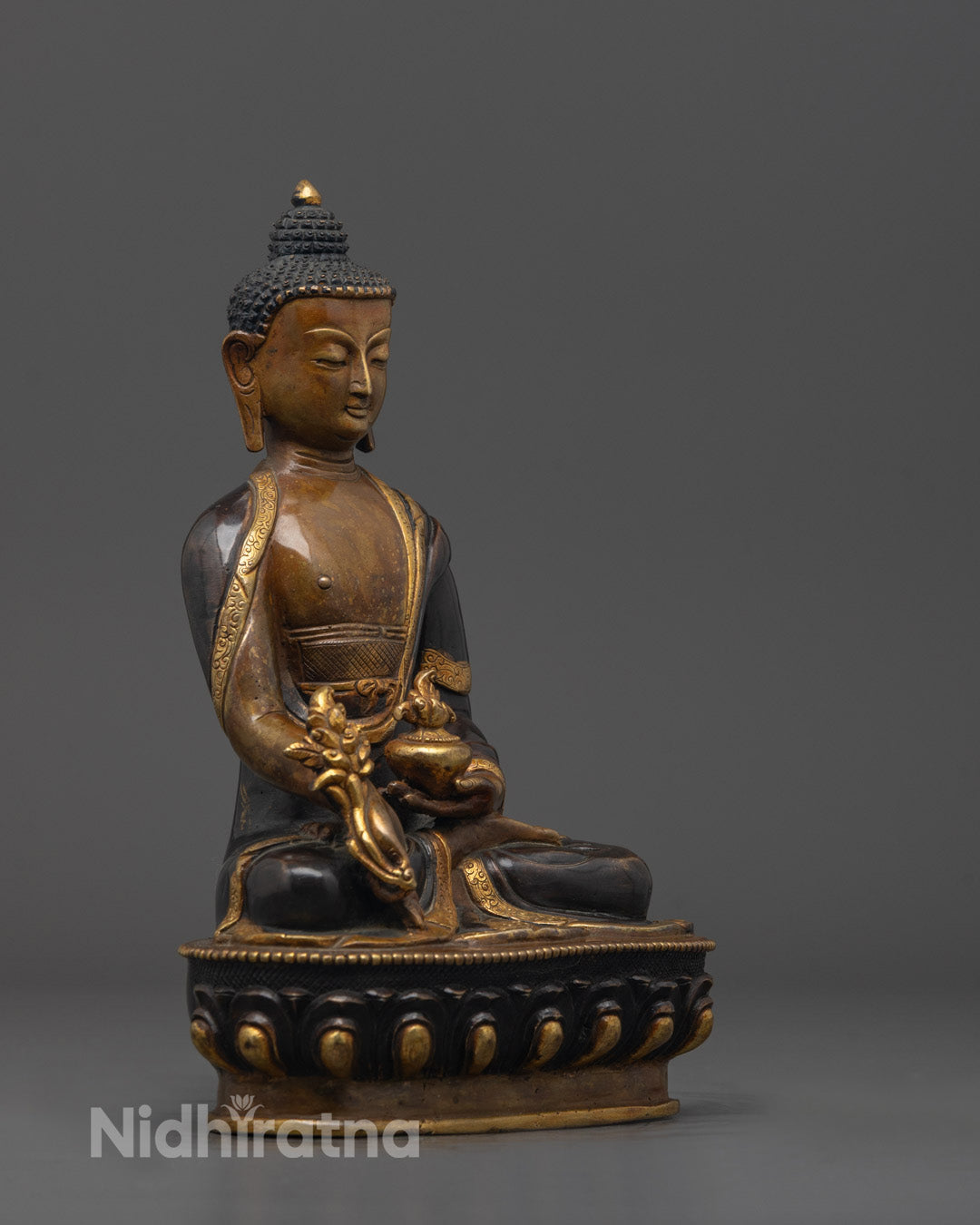 Side profile of hand-carved Medicine Buddha Statue showing intricate oxidized copper detailing