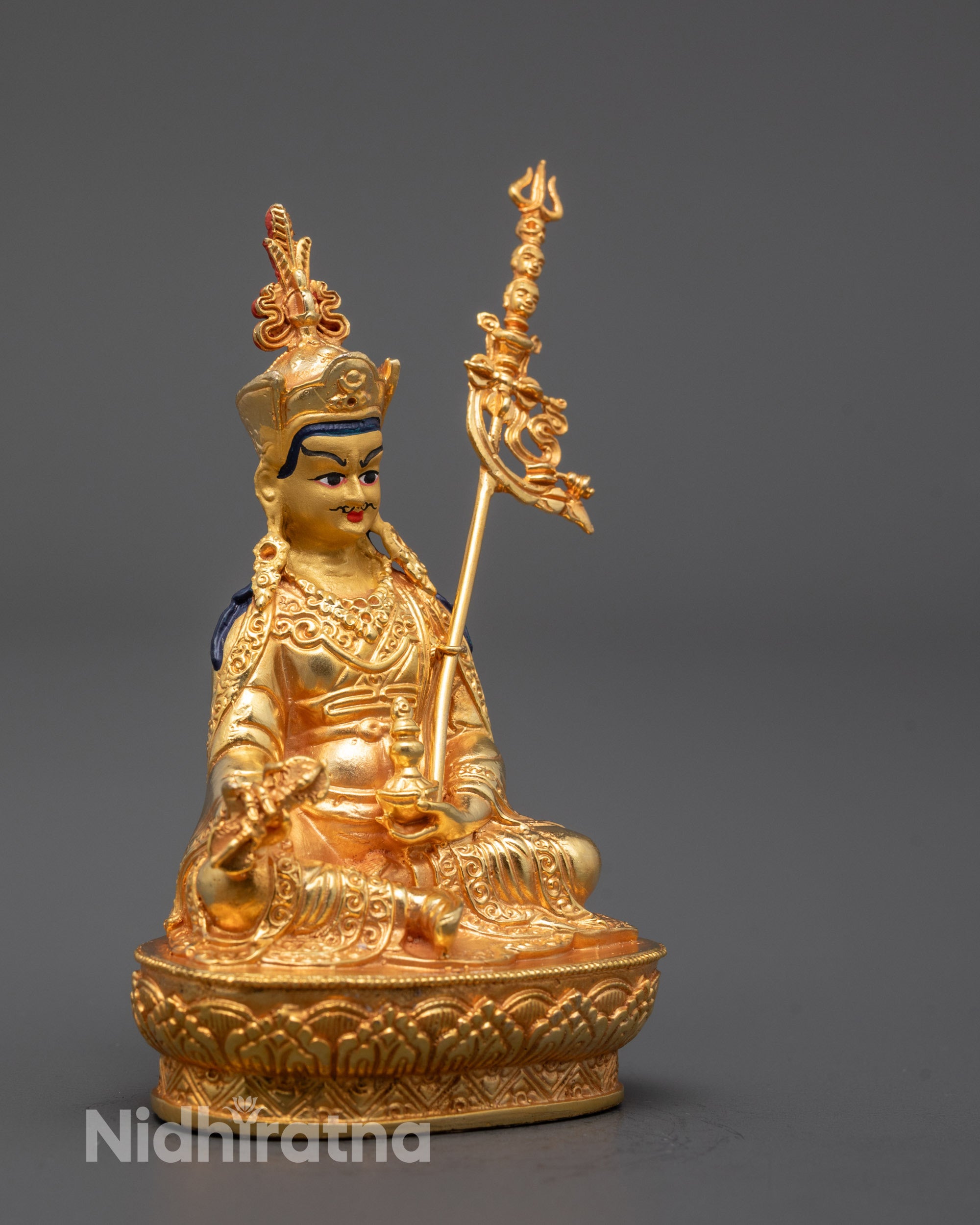 Side profile of handcrafted Guru Rinpoche sculpture seated on a lotus throne