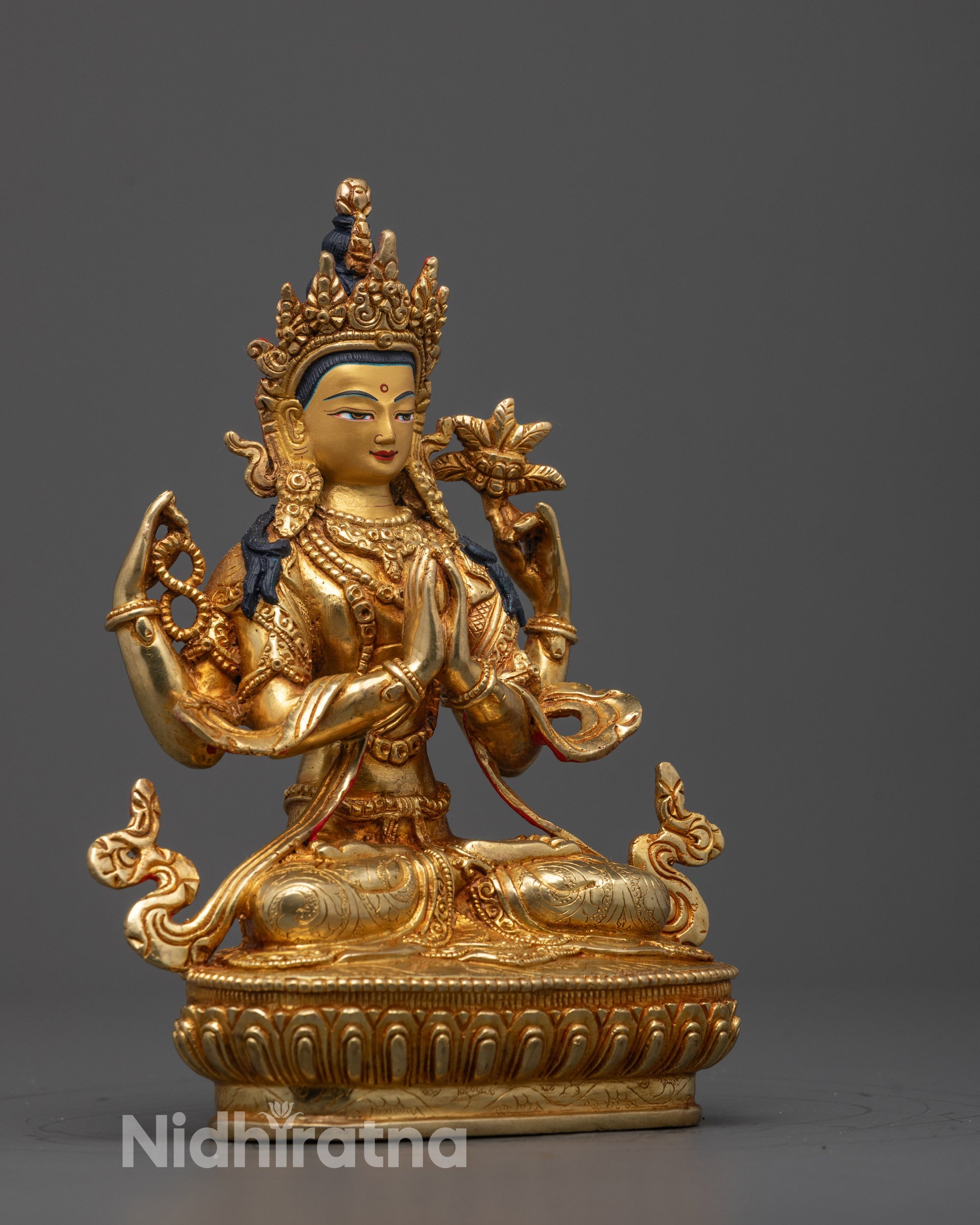 Side profile showing detailed robes and arm positions of Chenrezig copper statue