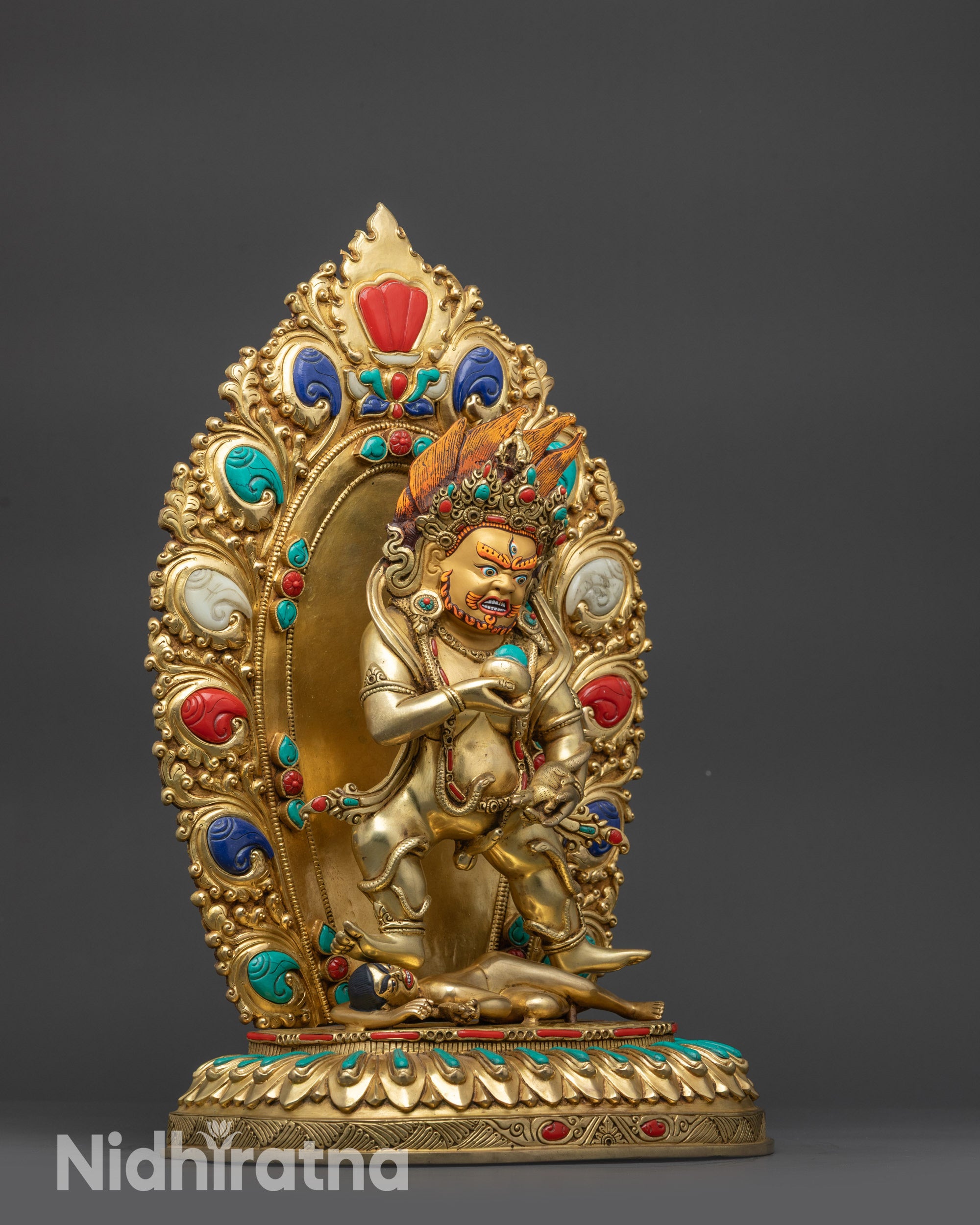 Side view Black Dzambhala Statue showing serpent ornament, skull crown, and tiger-skin robe