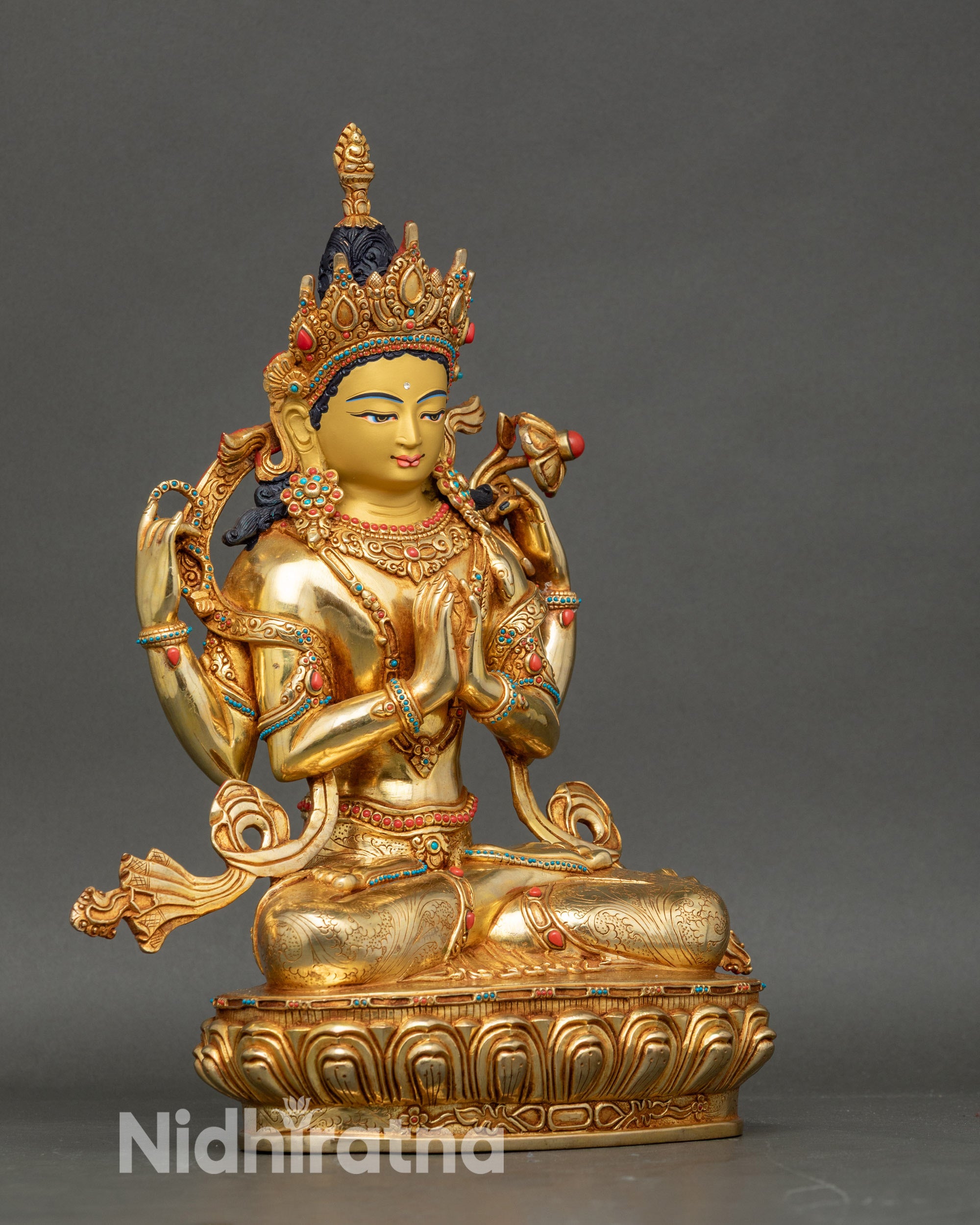 Side view Chenrezig statue seated in vajra posture on lotus pedestal