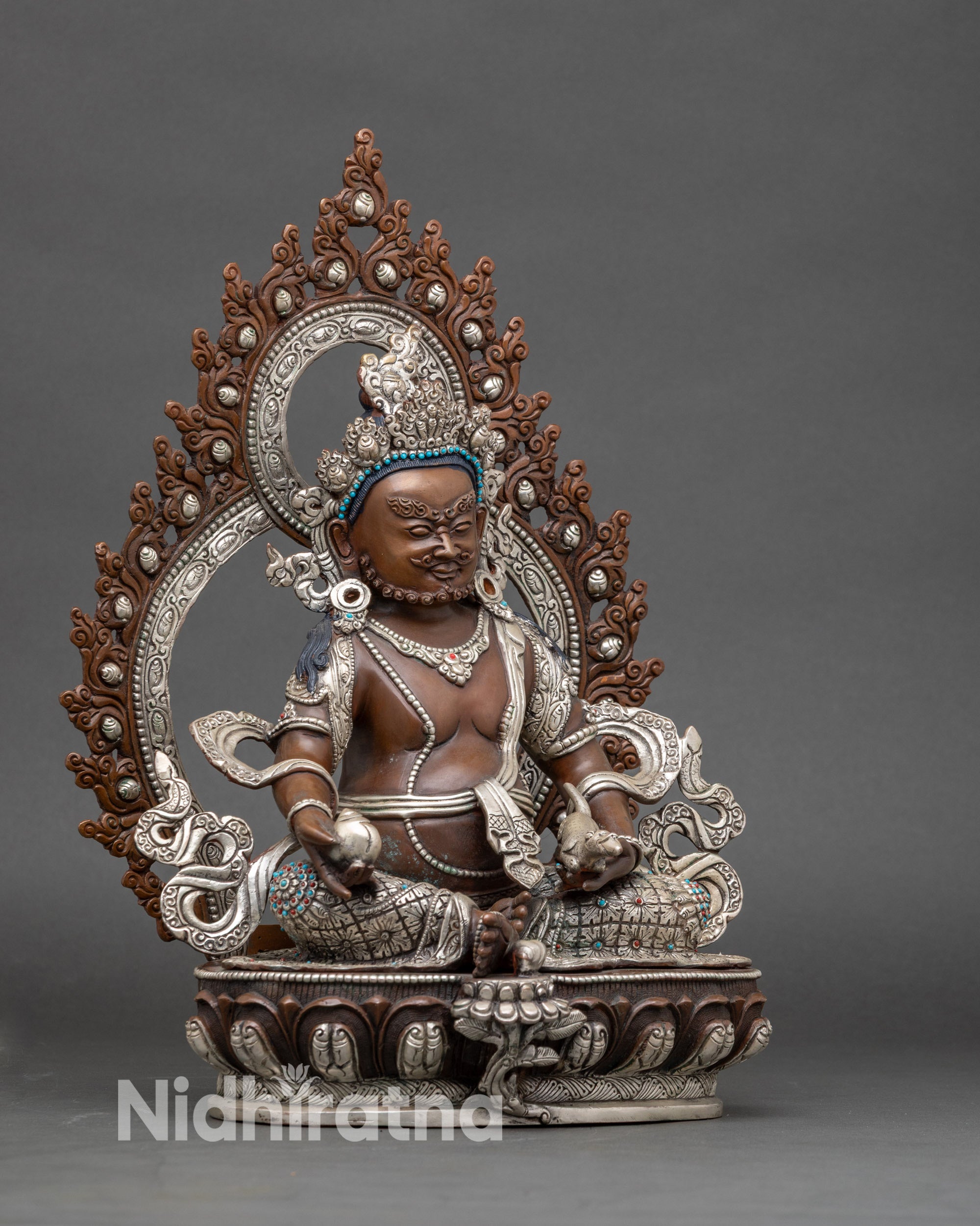 Side view Dzambhala Buddhist wealth statue with royal ease posture, lotus throne and conch shell