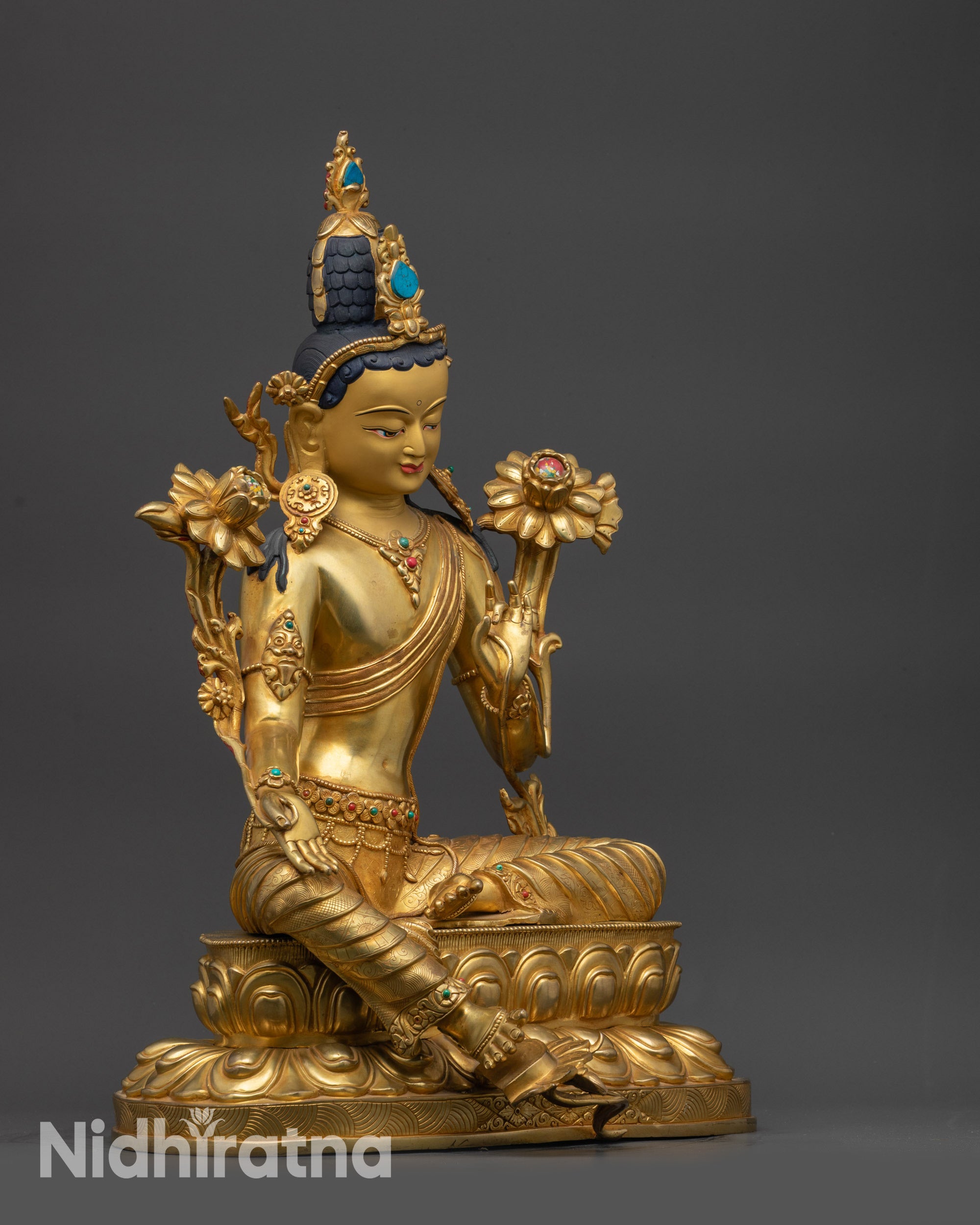Side view Green Tara Statue seated on double-lotus seat with one foot on bloomed lotus