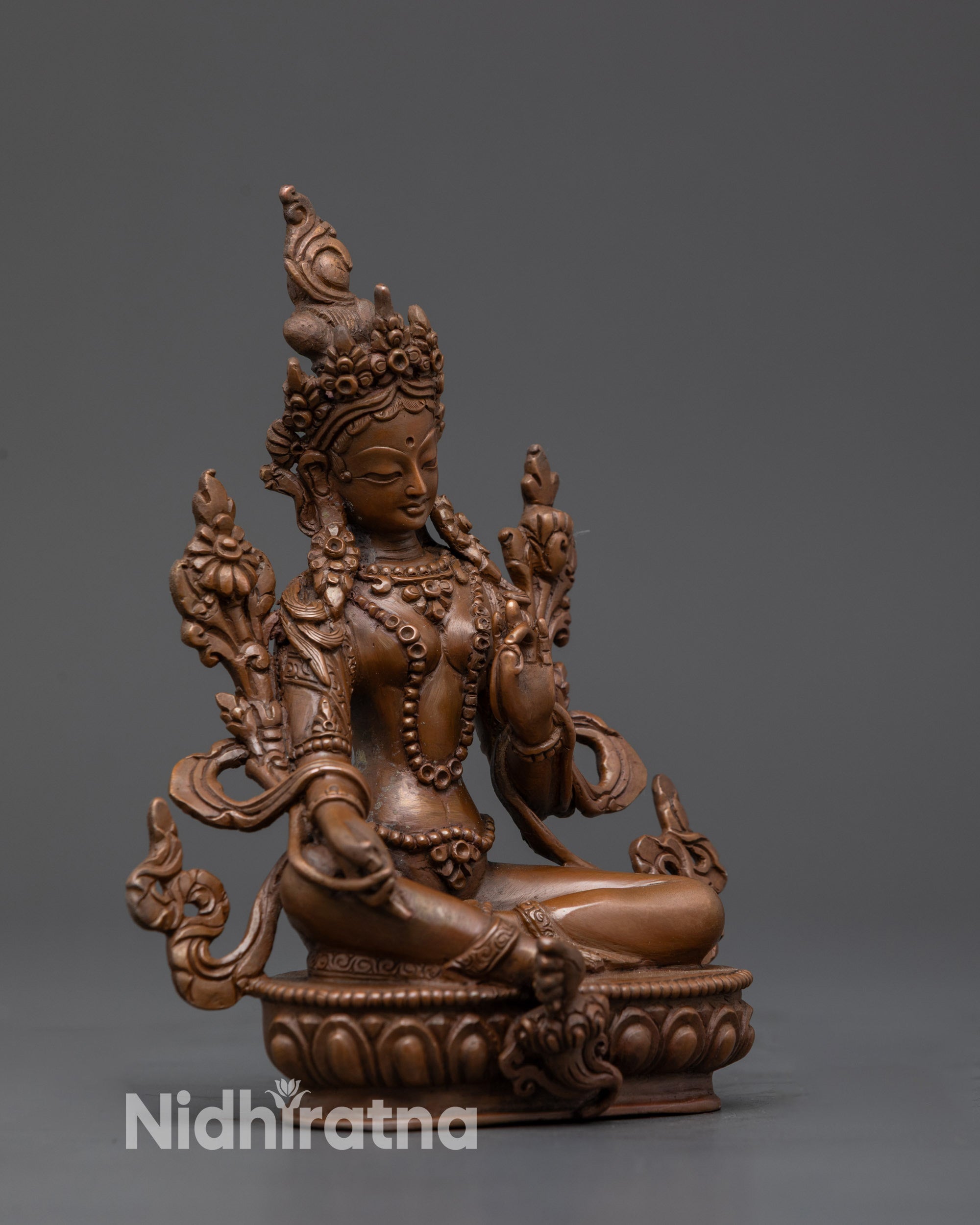 Side view Green Tara oxidized copper statue with Utpala flower and tranquil gaze