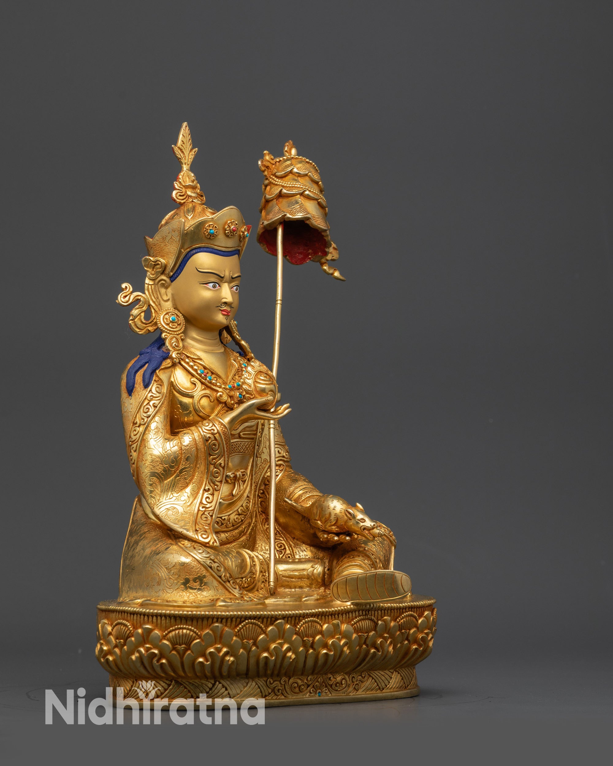 Side view Guru Norlha holding chintamani, mongoose, and parasol on shoulder