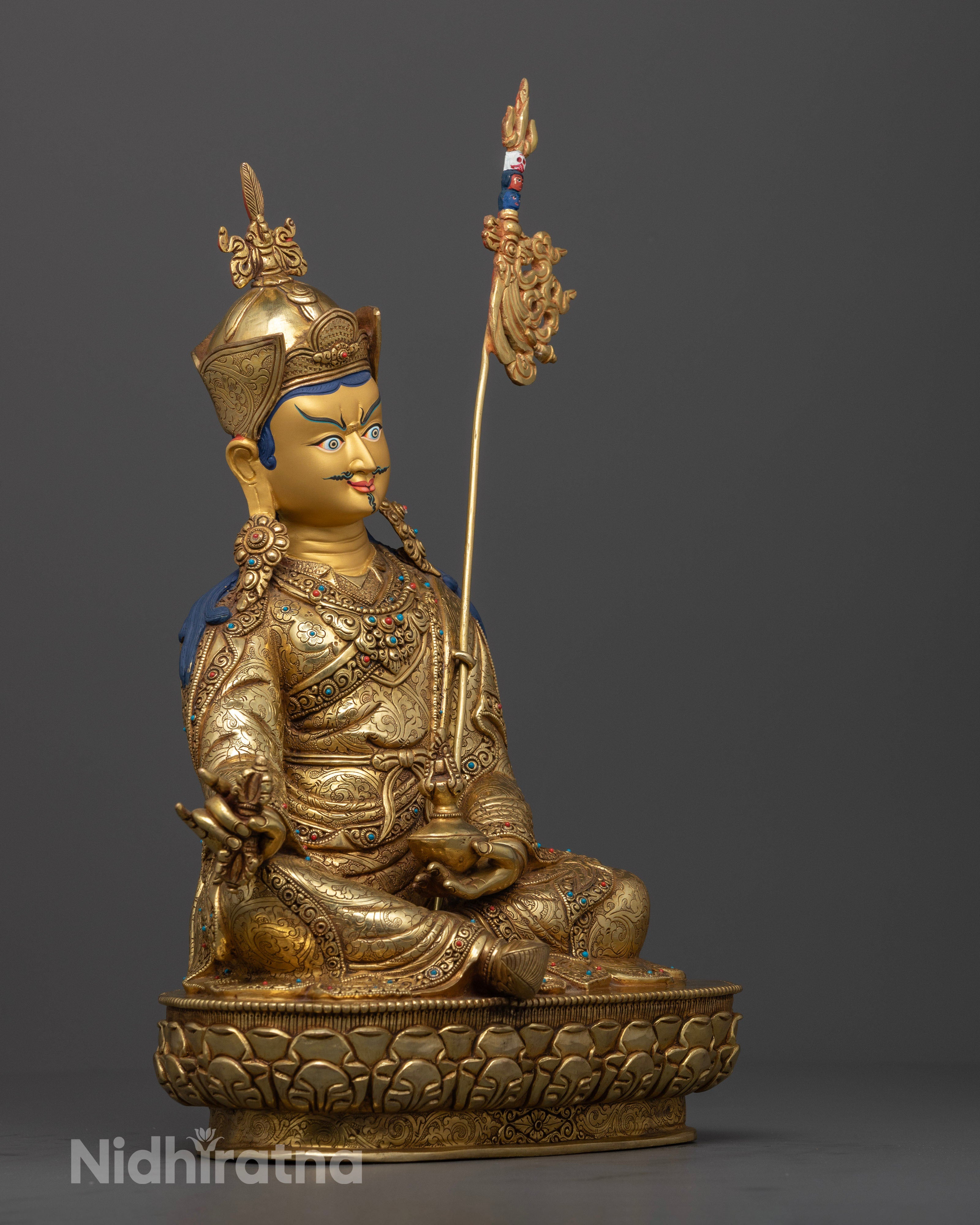 Side view Guru Rinpoche statue holding kalash and dorje, lotus hat and kasaya robes, Nepalese copper artwork