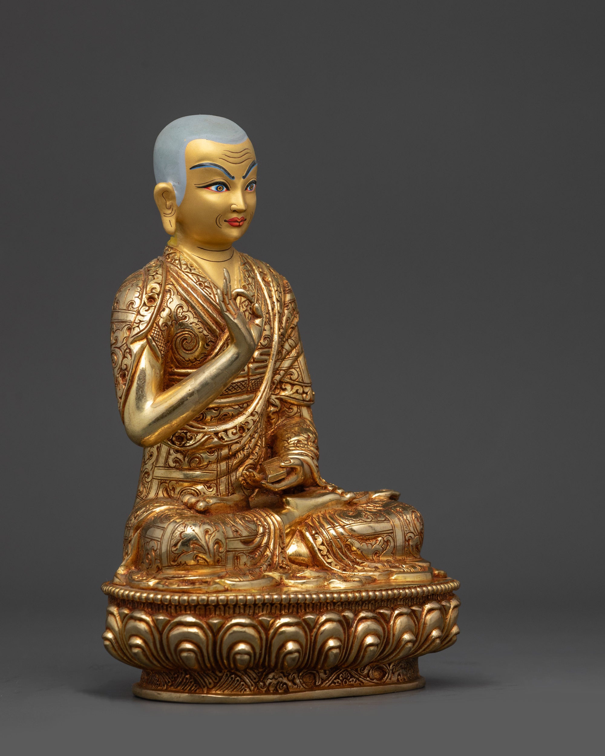 Side view Gyaltsab Je statue with intricately carved monastic robes