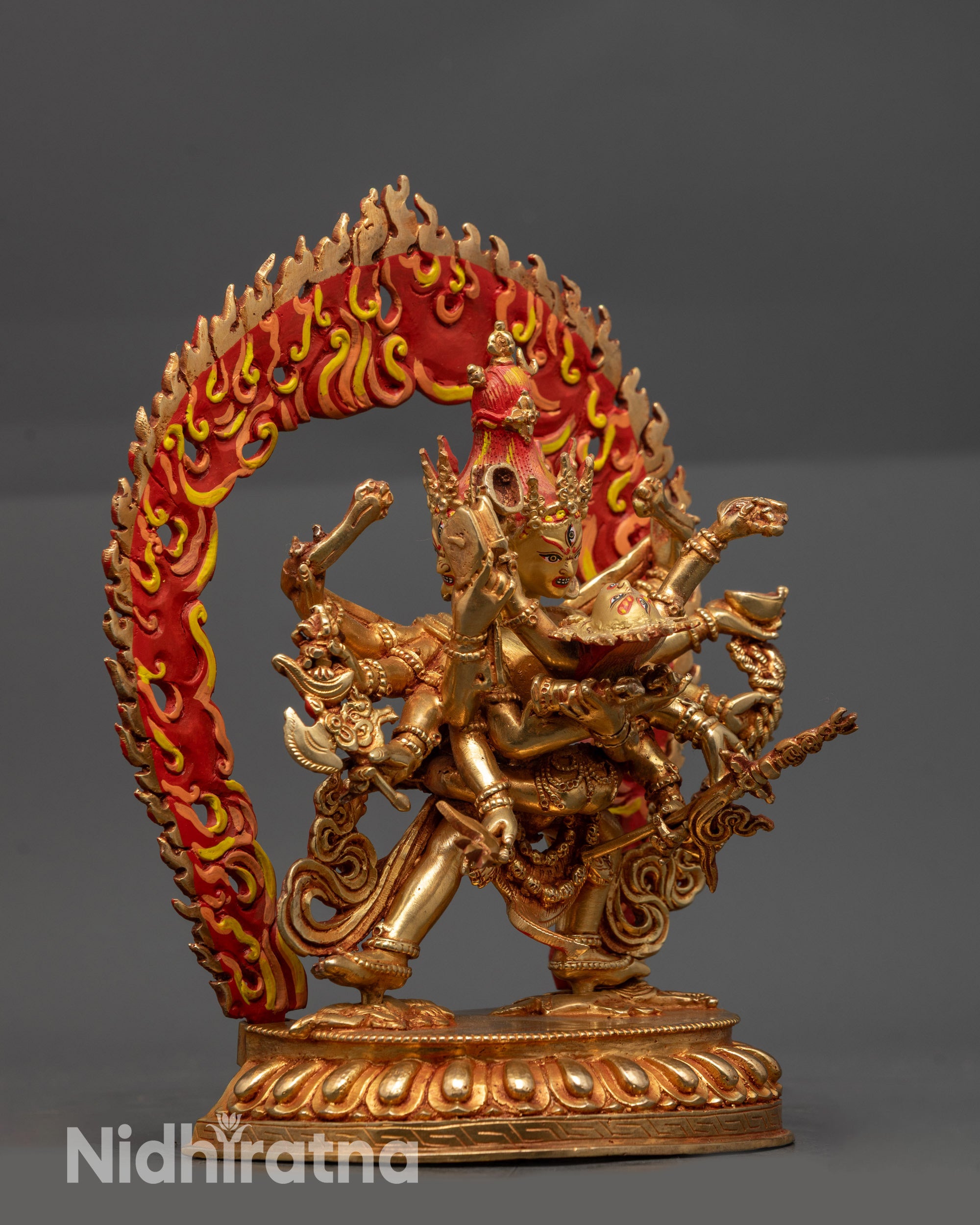 Side view Heruka Chakrasamvara twelve arms holding ritual objects on lotus seat