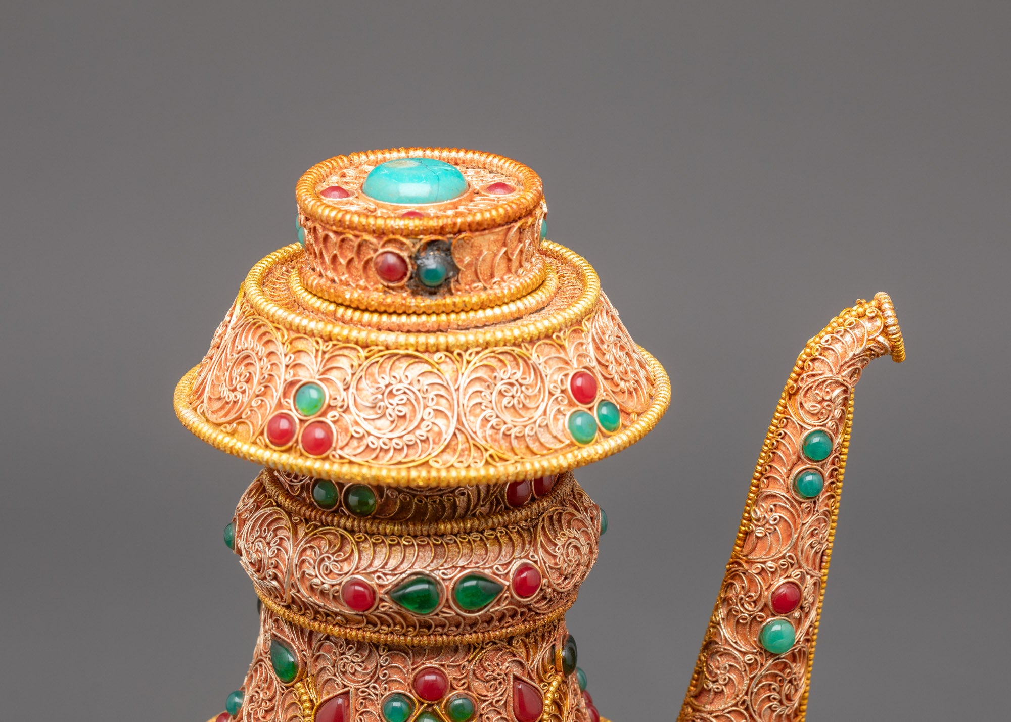Side view Himalayan Bhumba water offering vessel crafted with copper and gold filigree design