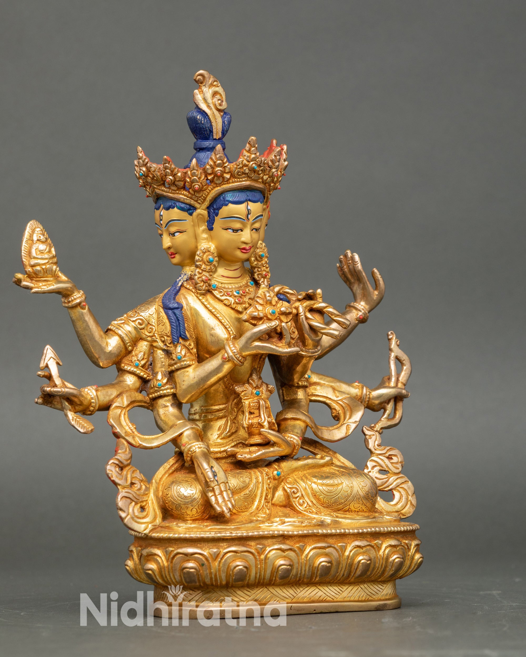 Side view Namgyalma statue, holding double vajra, bow, long-life vase, lotus with Buddha