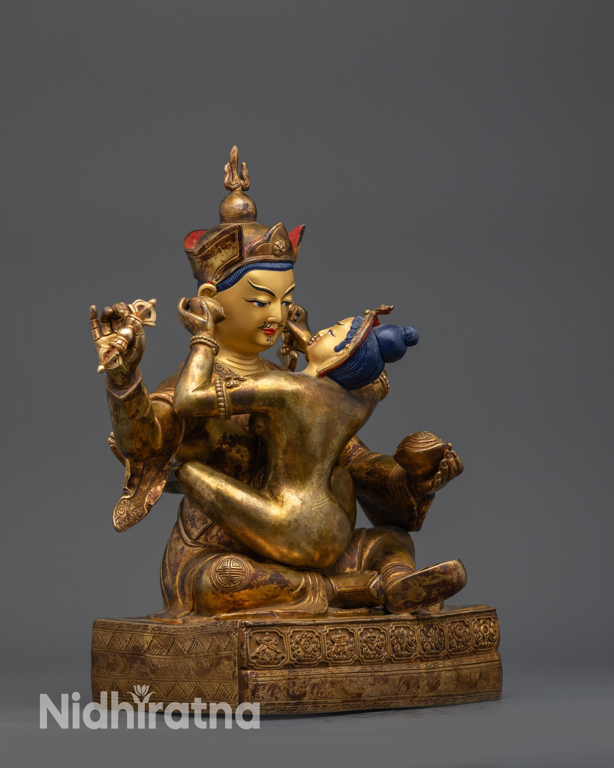 Side view Padmasambhava and Yeshe Tsogyal statue with vajra and kapala details