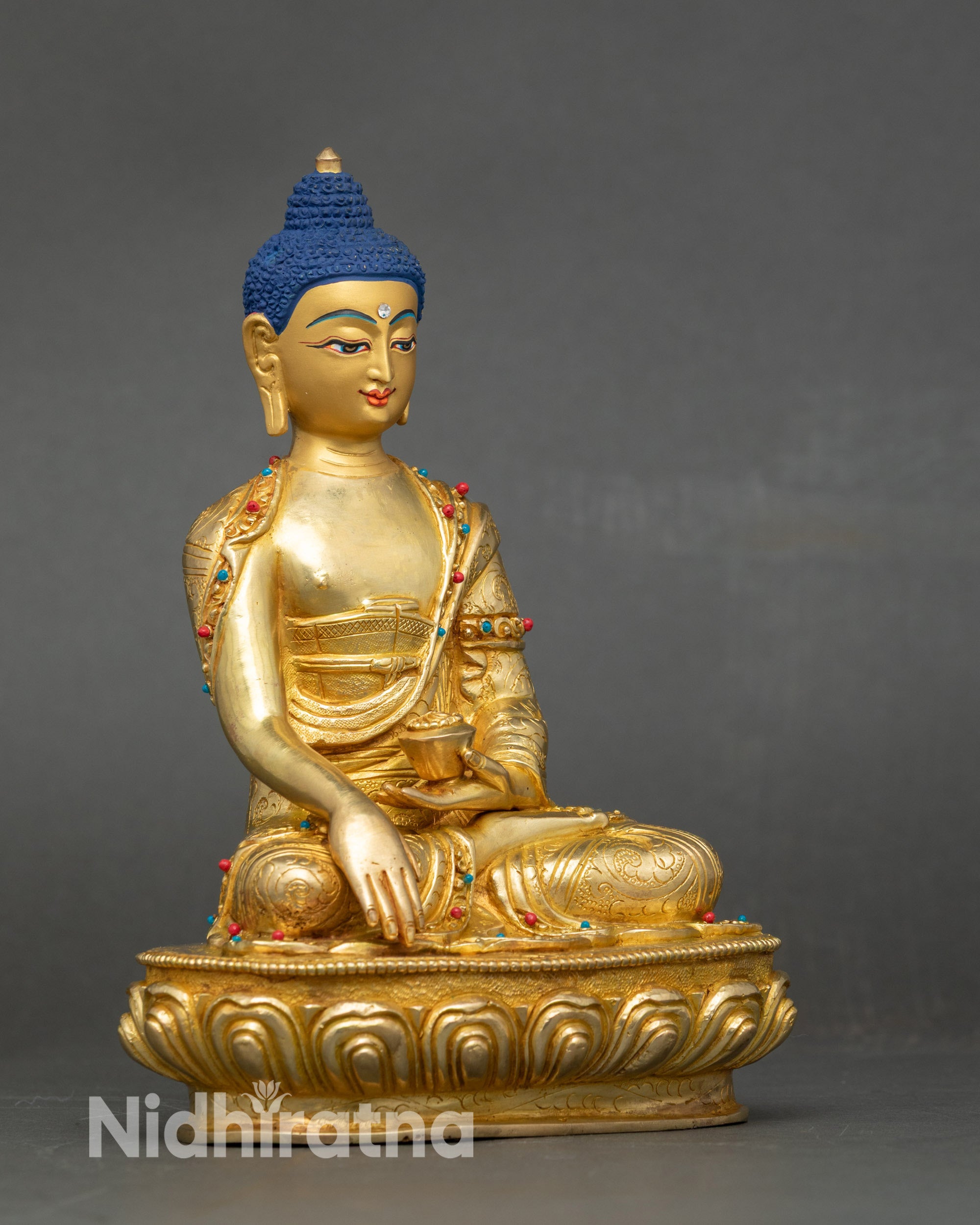 Side view Shakyamuni Buddha sculpture seated with Bhumisparsha Mudra and intricate robes