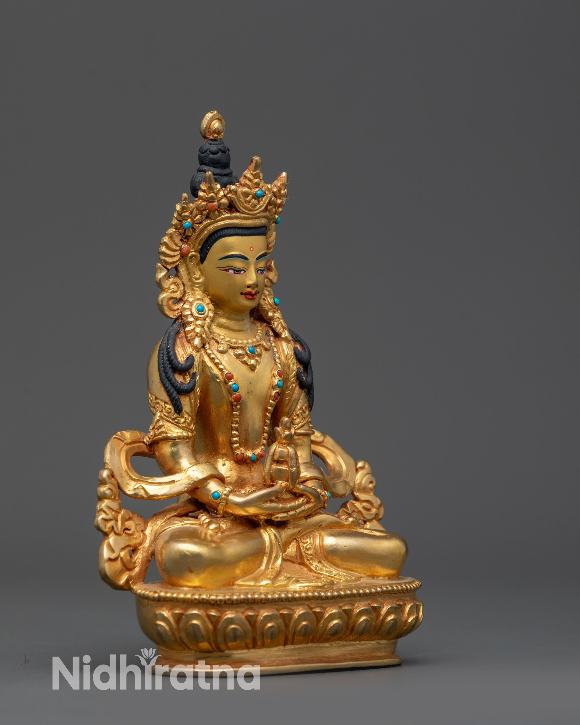 Side view Tibetan Amitayus statue highlighting robes and intricate craftsmanship