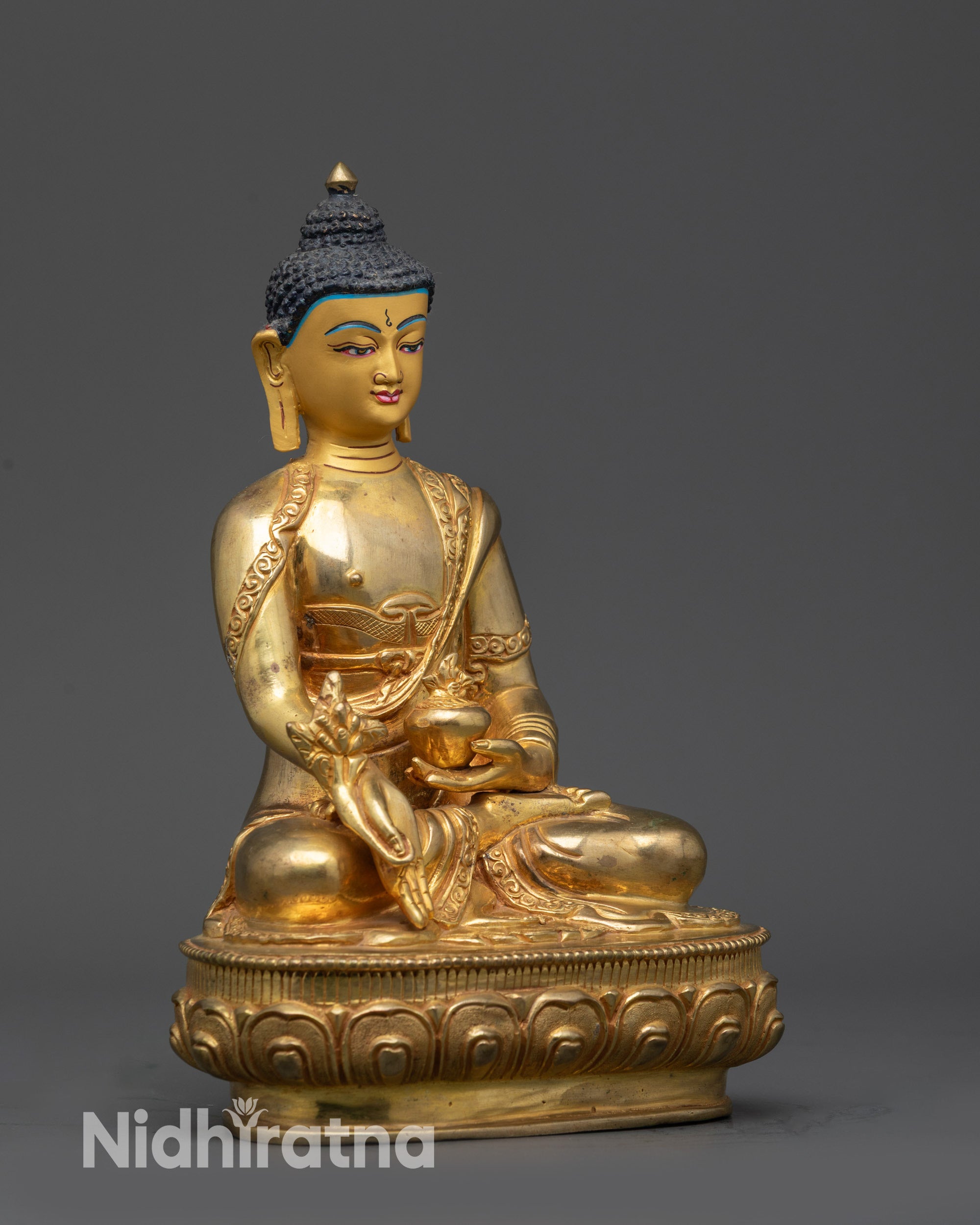 Side view Tibetan Bhaisajyaguru statue draped in flowing Buddhist monk's robe