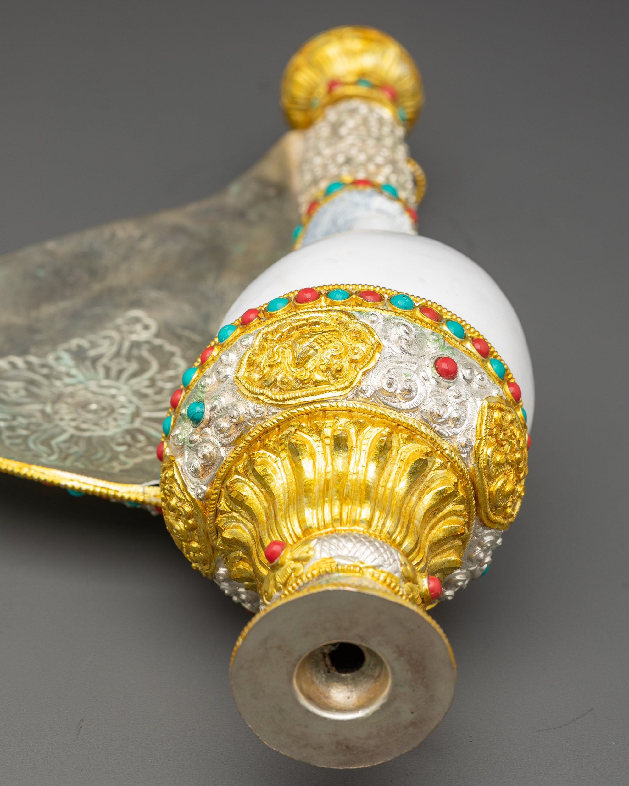 Side view Tibetan Conch Shell with ornamental carvings and temple-like base for rituals