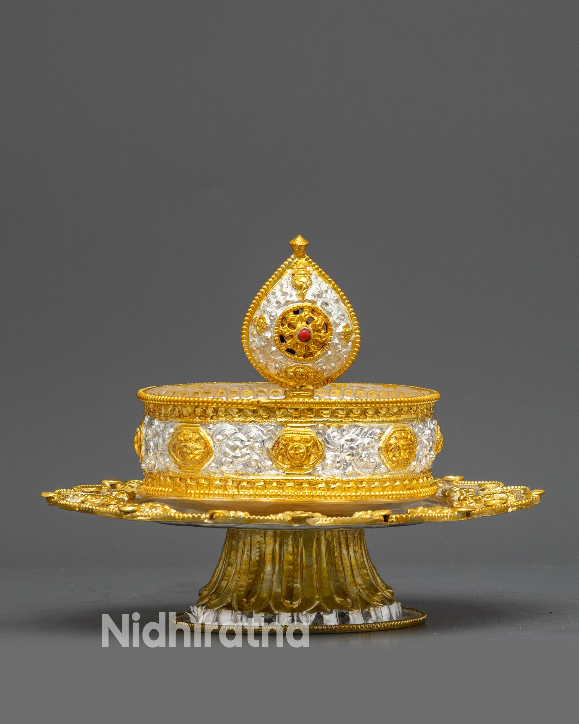 Side view Tibetan Mandala on pedestal with layered ceremonial rice offerings