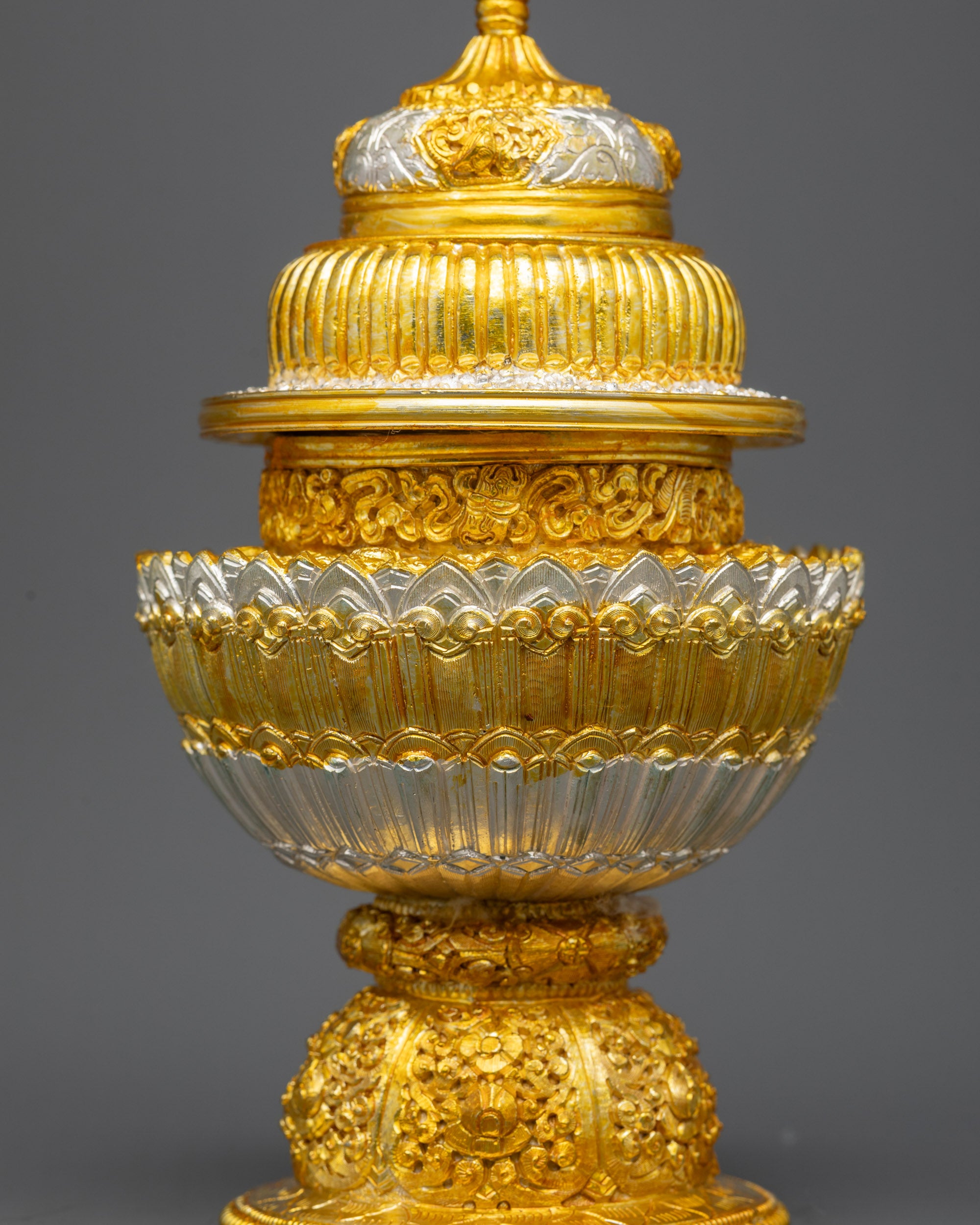 Side view Tibetan Neshi Rice Pot showing rounded bowl and ornamented pedestal base