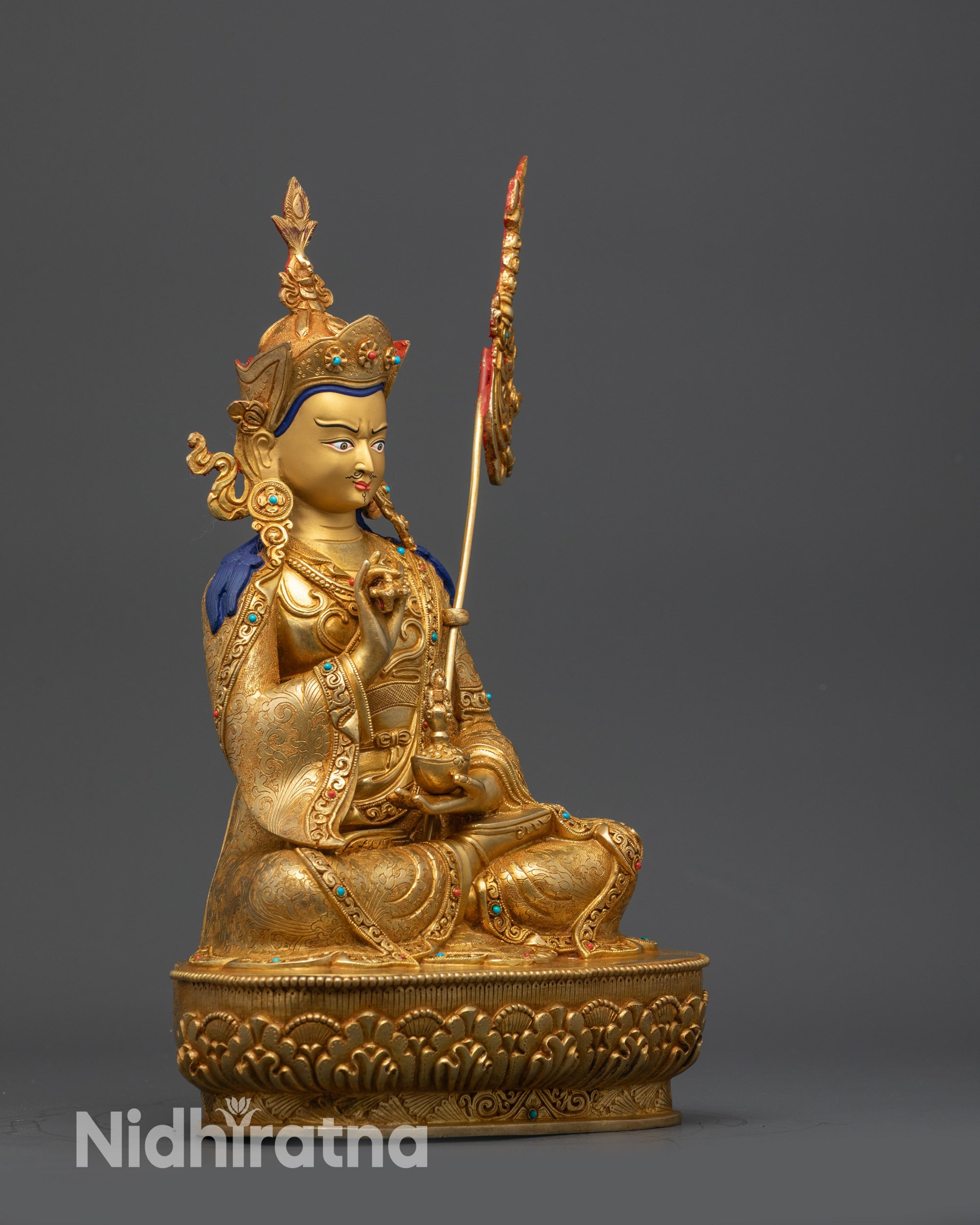 Side view Tsokye Dorje statue showing ornate khatvanga staff and detailed crown finial