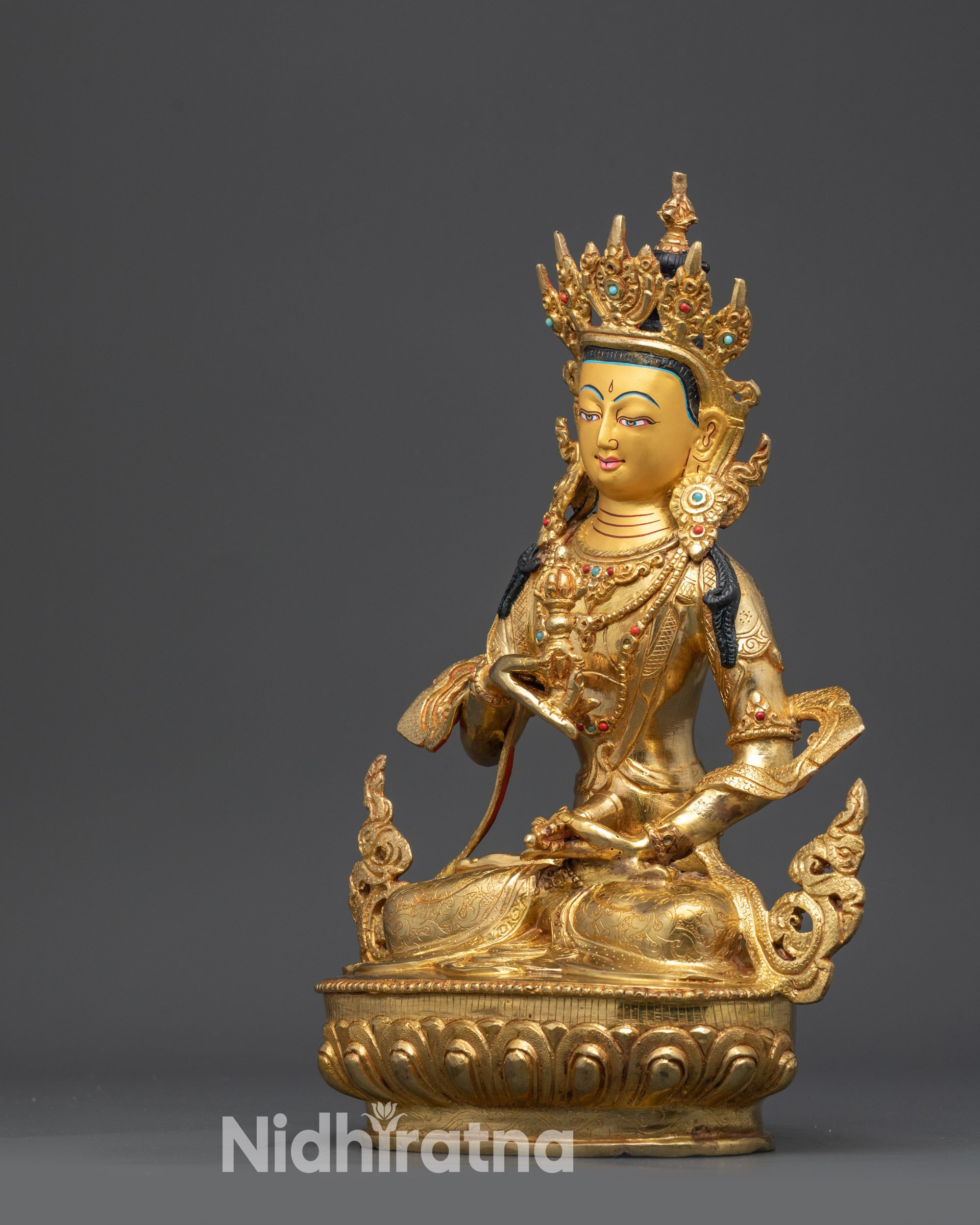Side view Vajrasattva statue showing flowing robe and intricate lower garment