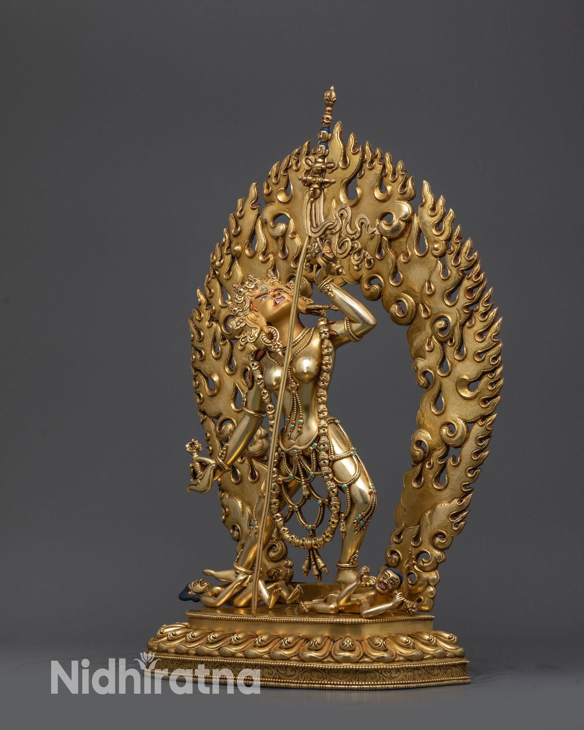 Side view Vajrayogini Statue with swirling robes and trident on shoulder