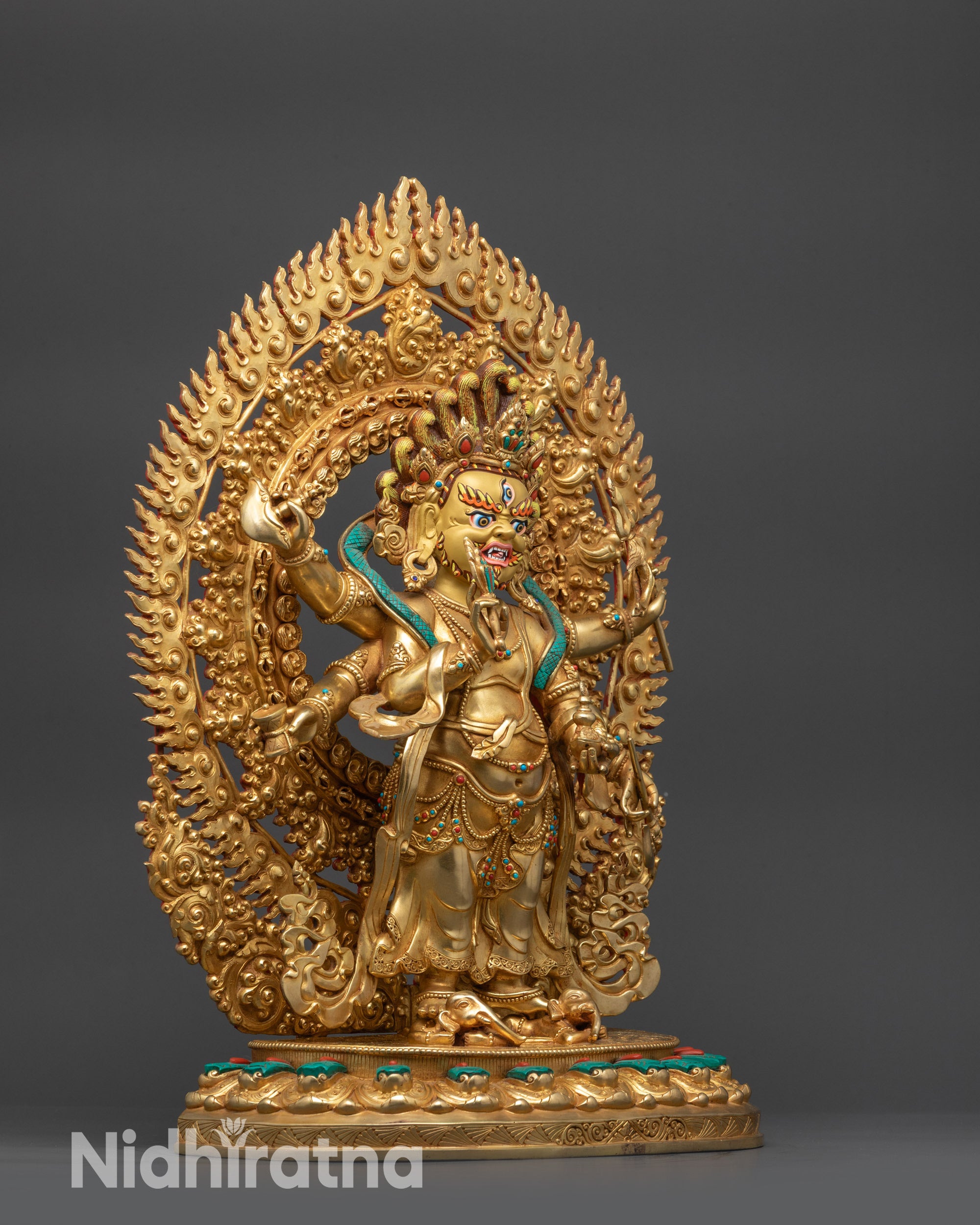 Side view White Mahakala Sculpture showing swirling turquoise robes and jewelry