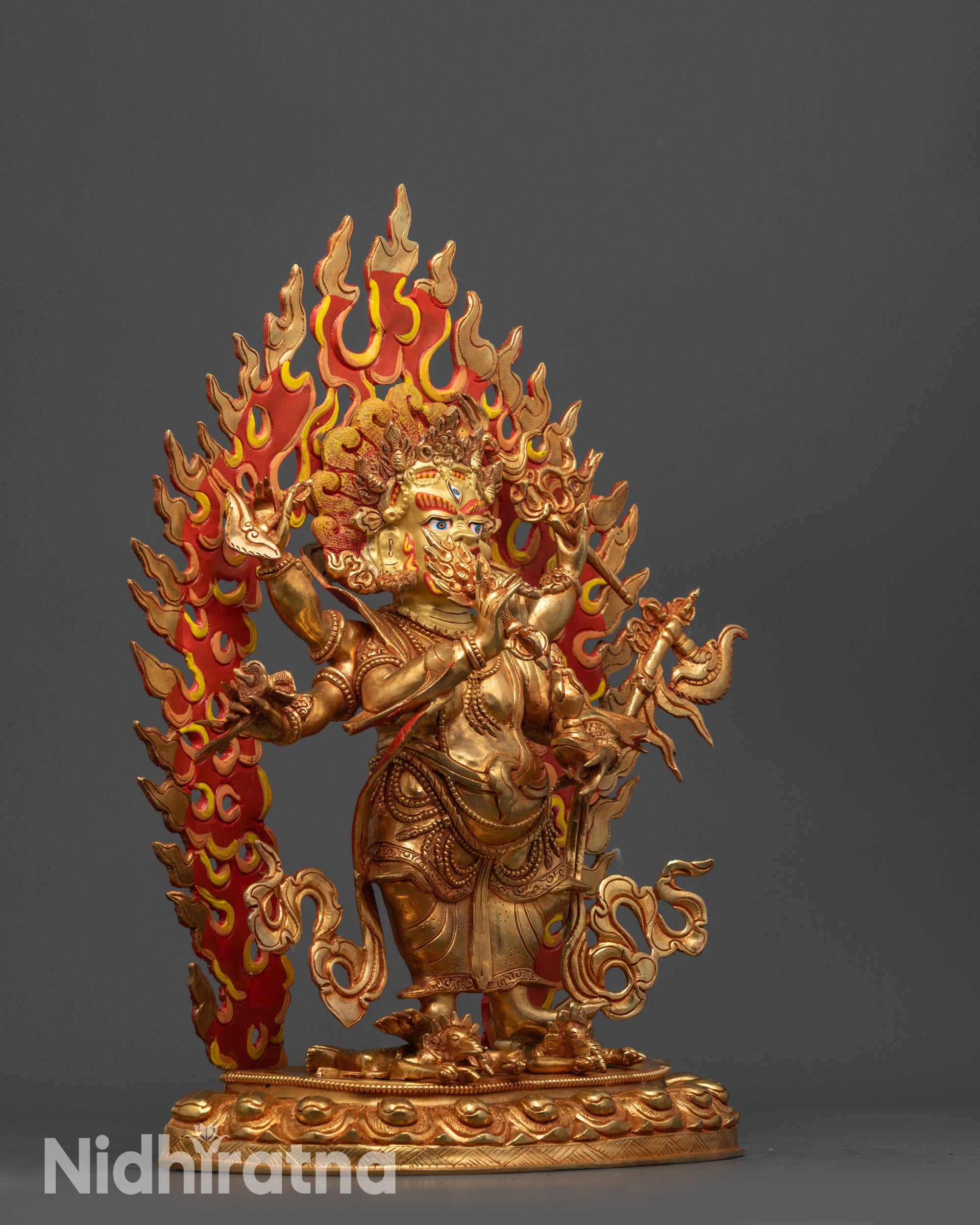 Side view White Mahakala statue with flowing robe, crown, and jewelry on lotus seat