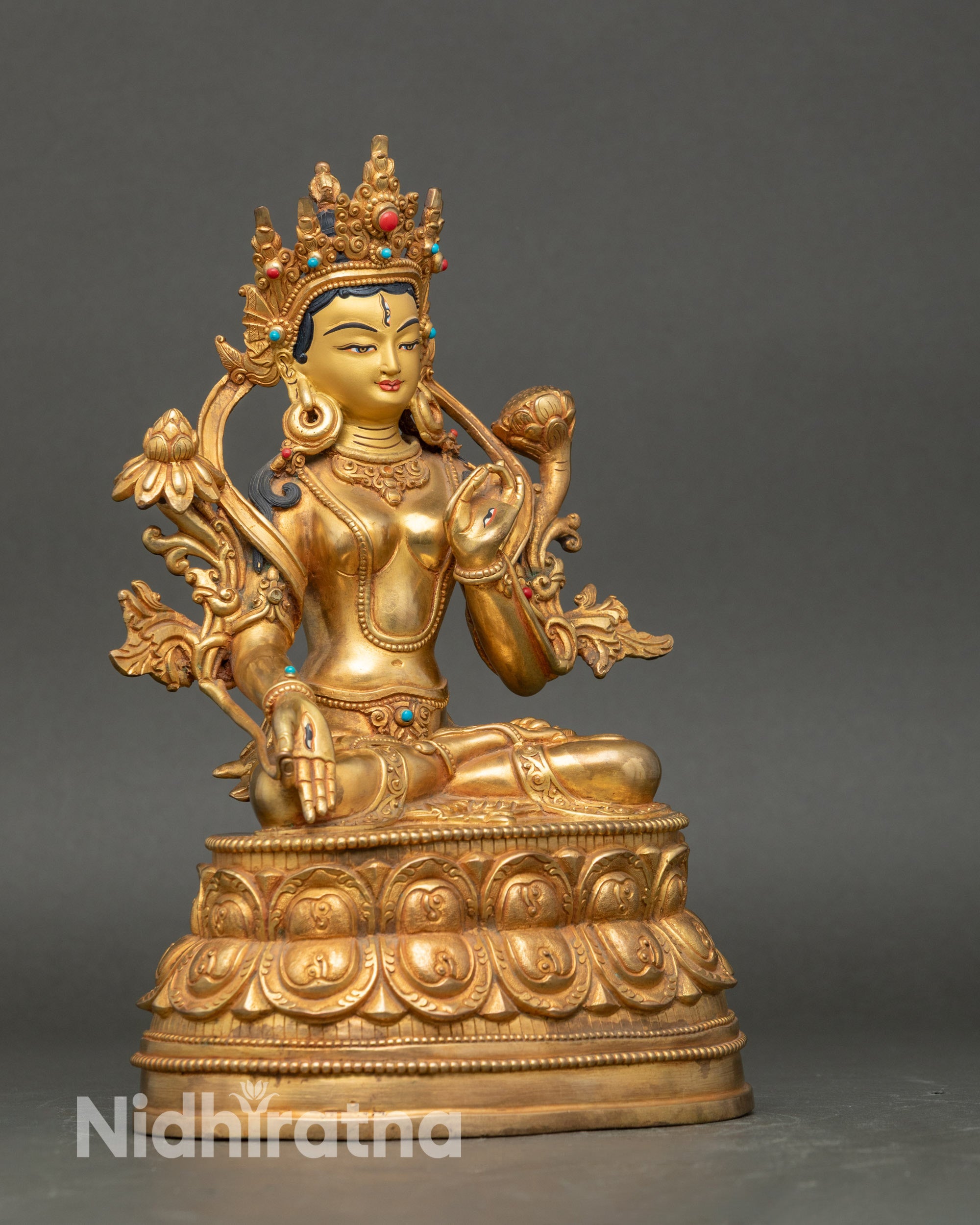Side view White Tara statue, holding utpala flower, Varada and Vitarka mudra, five-jeweled crown
