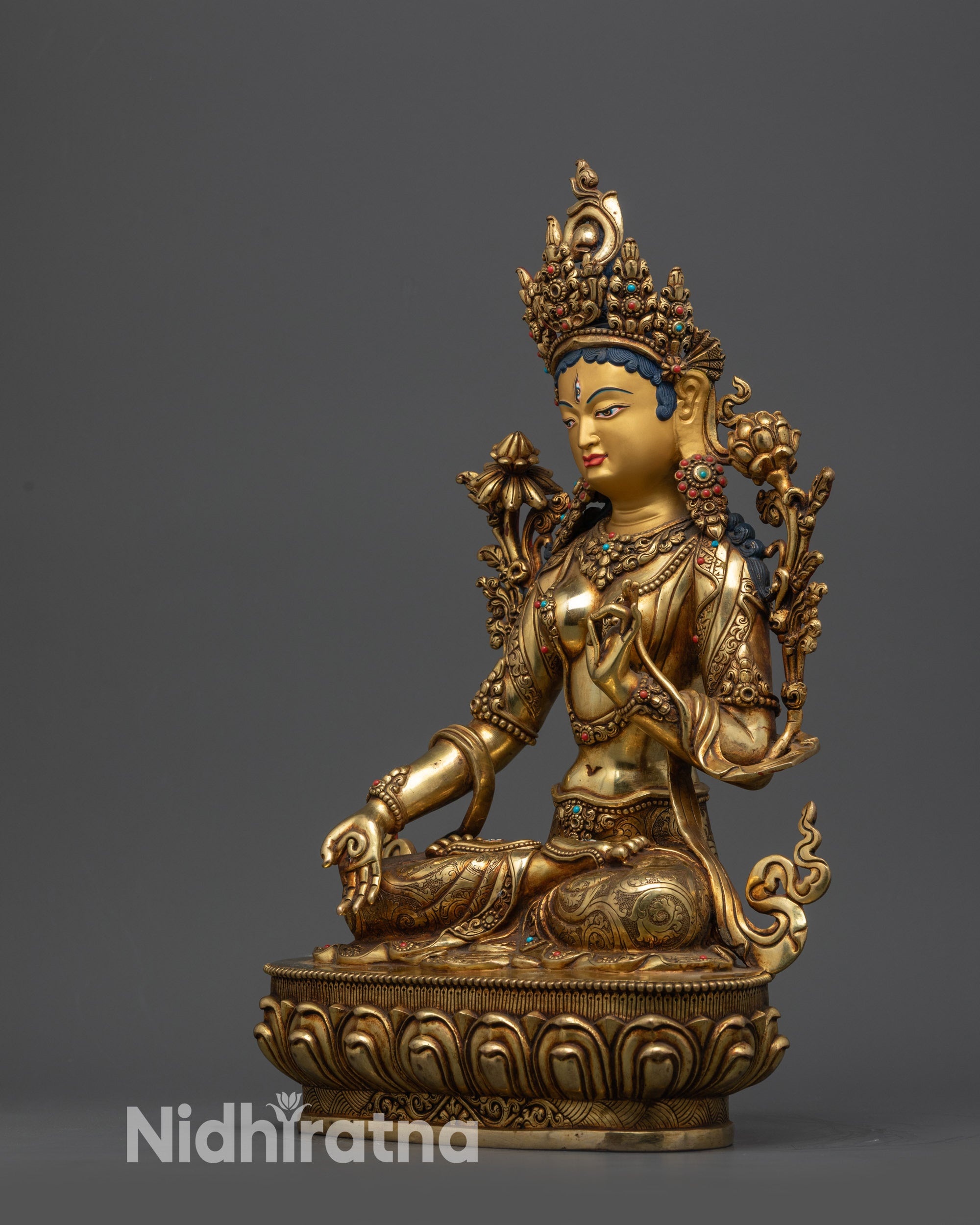 Side view White Tara statue with five-jeweled crown and flowing semi-precious robe