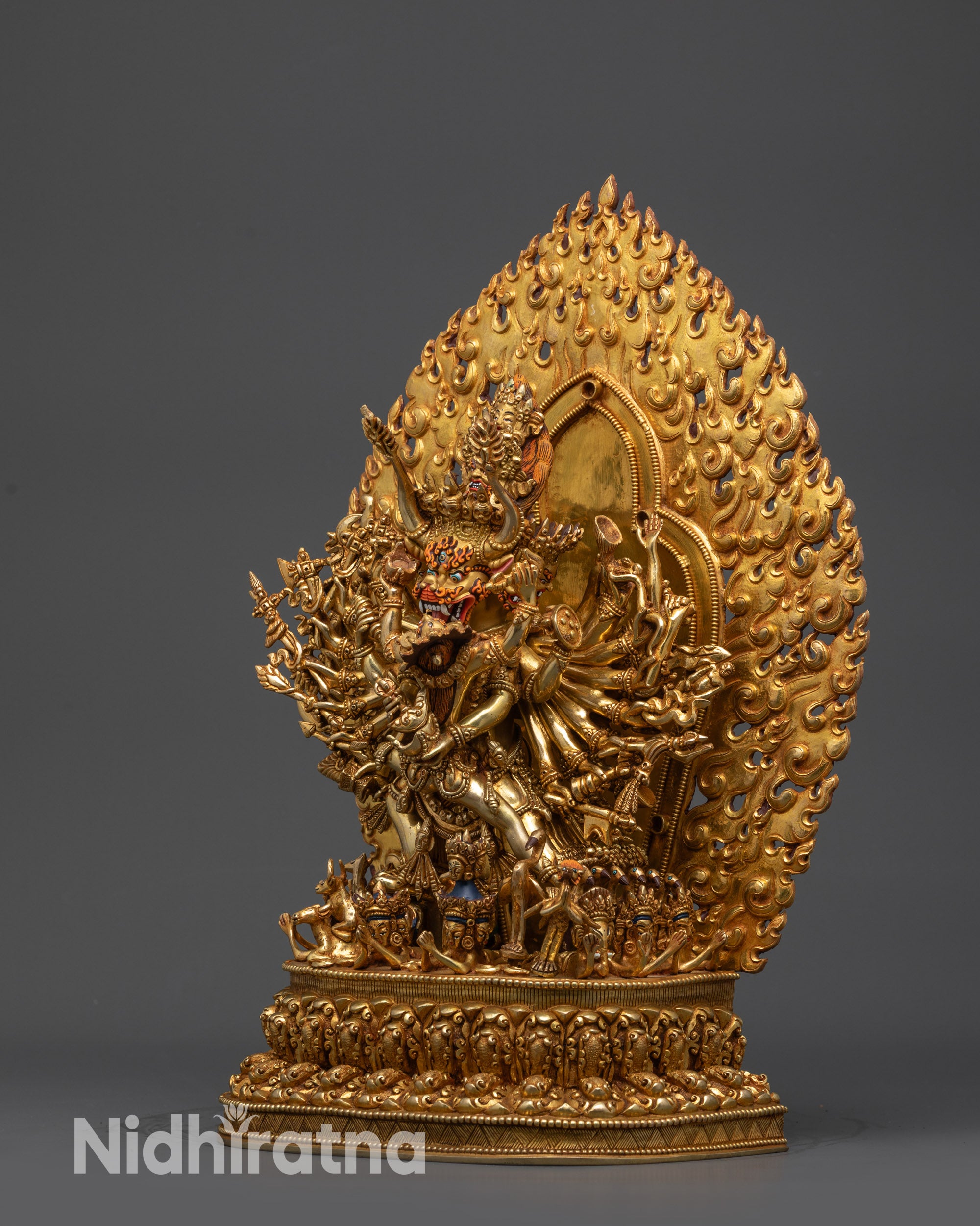 Side view Yamantaka standing in consort atop intricately carved lotus with flaming halo