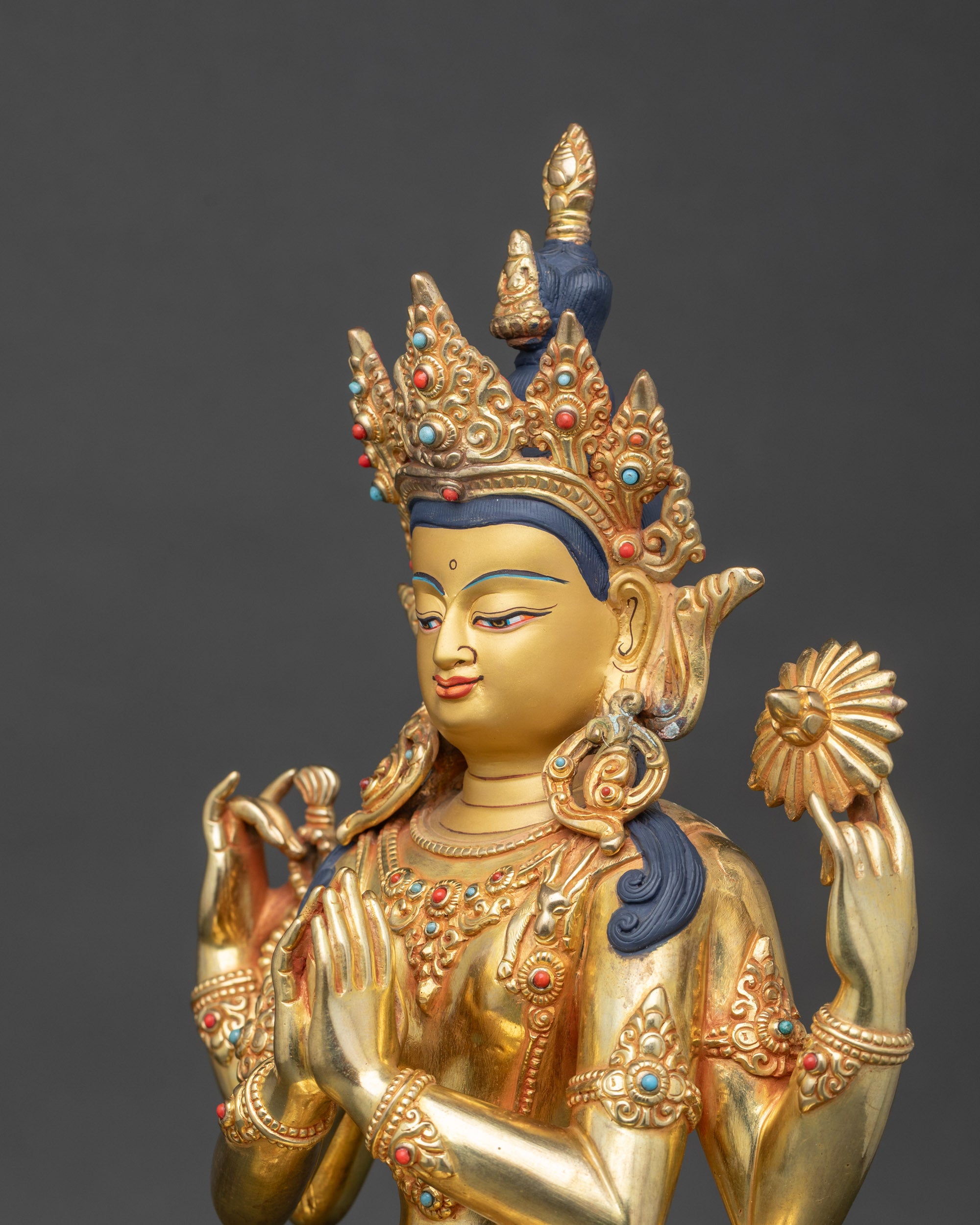 Side view close-up of Chenrezig robes adorned with turquoise and coral stones