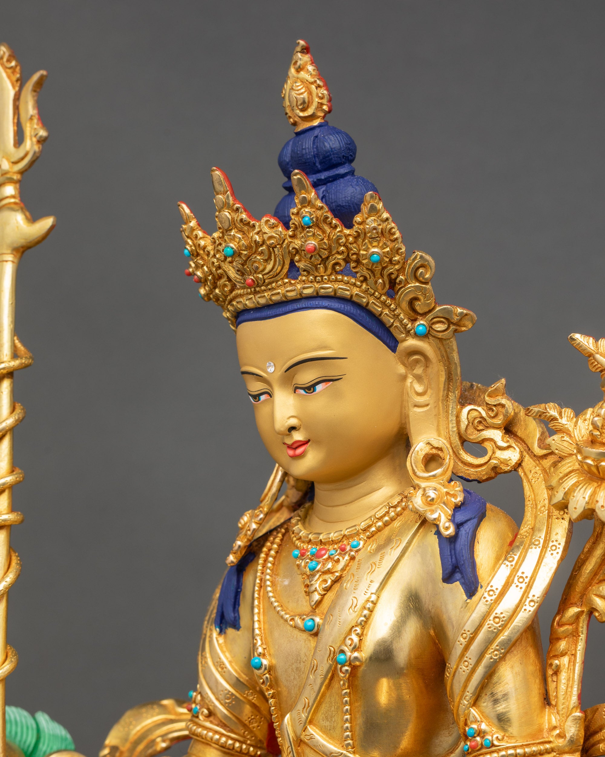 Side view close-up of Simhada Chenrezig showing trident and flowing garments