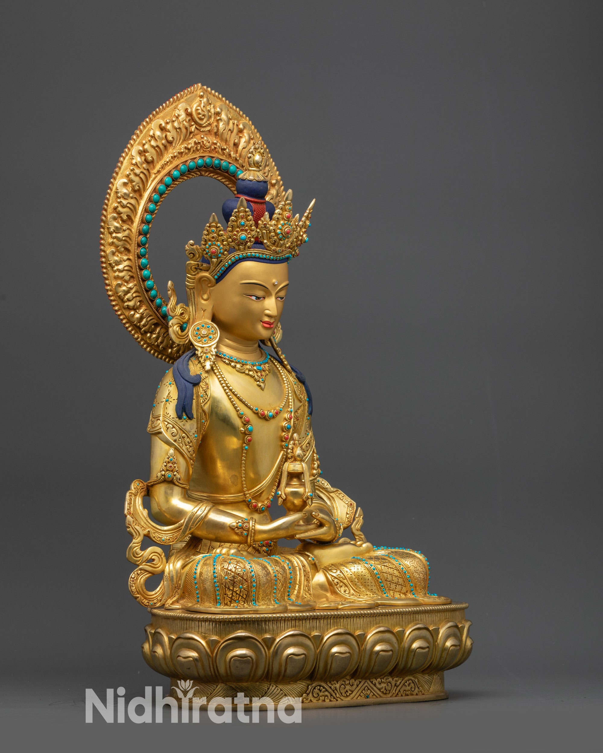 Side view of Amitayus Buddha seated on lotus pedestal holding vase of immortality