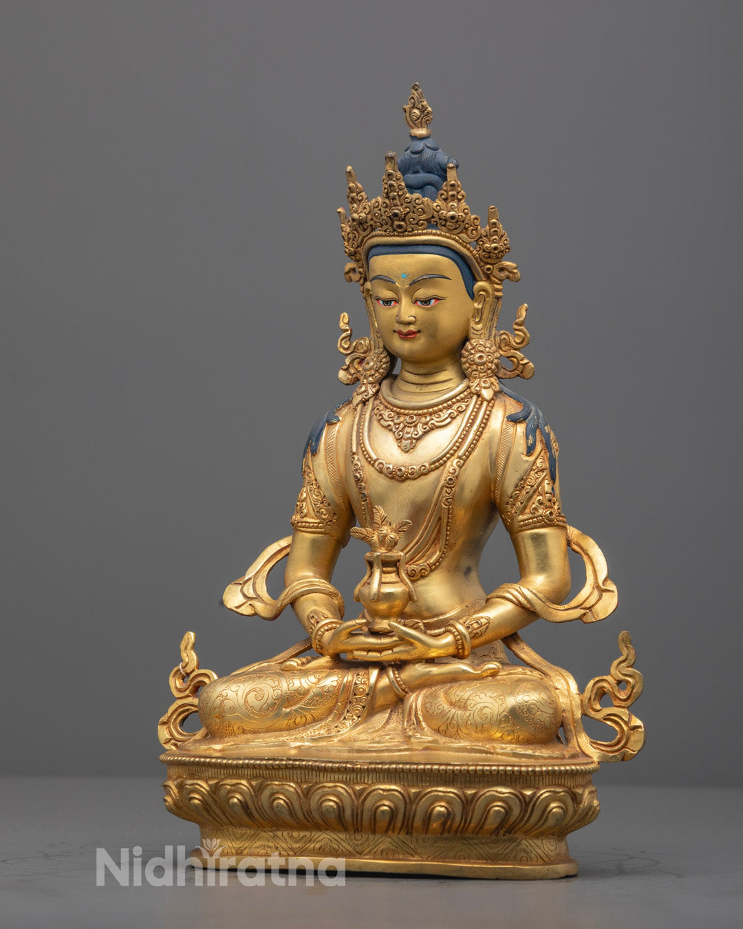 Side view of Amitayus Buddha statue showing detailed craftsmanship and gold finish