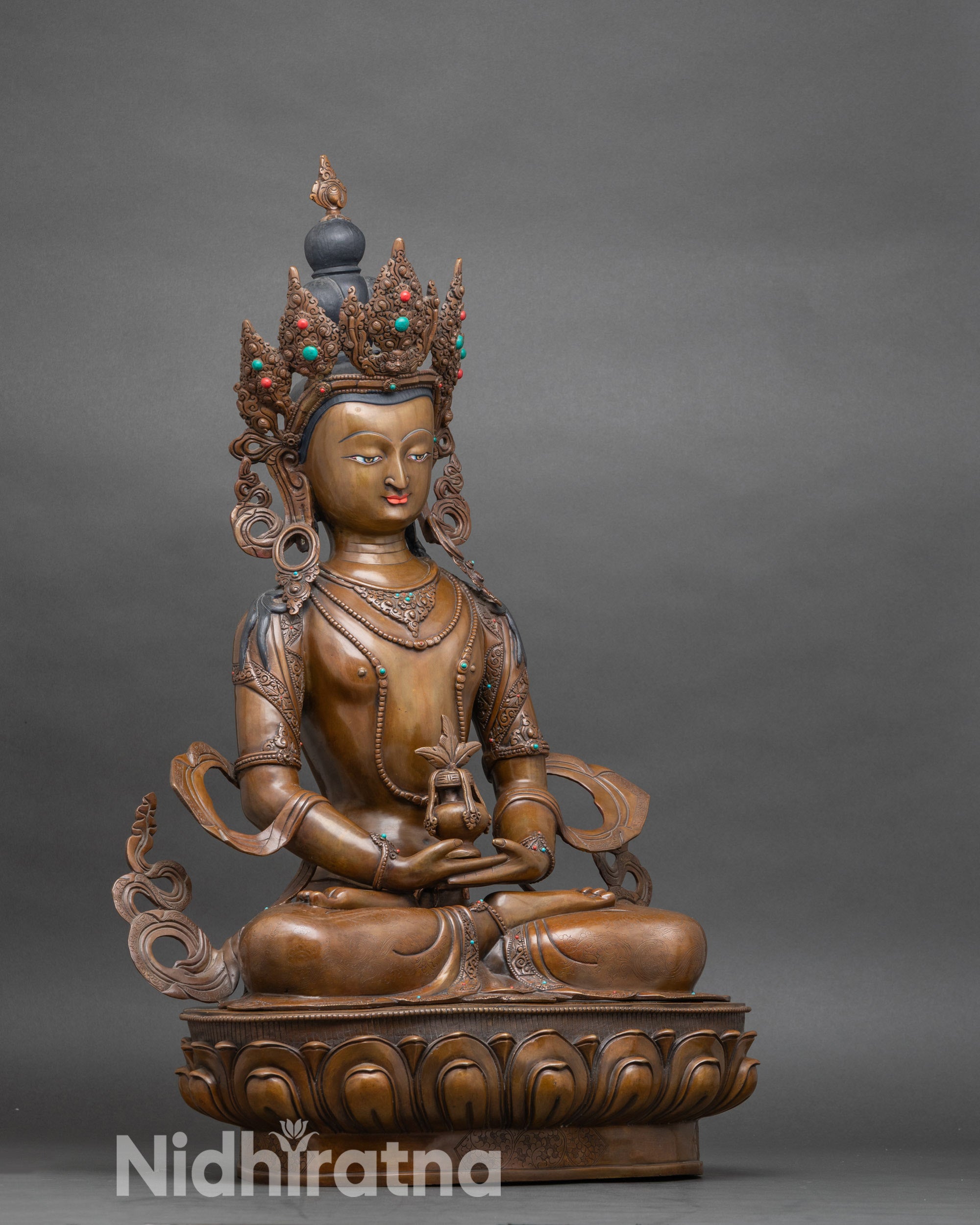 Side view of Amitayus Himalayan statue with chemically oxidized finish and lotus pedestal