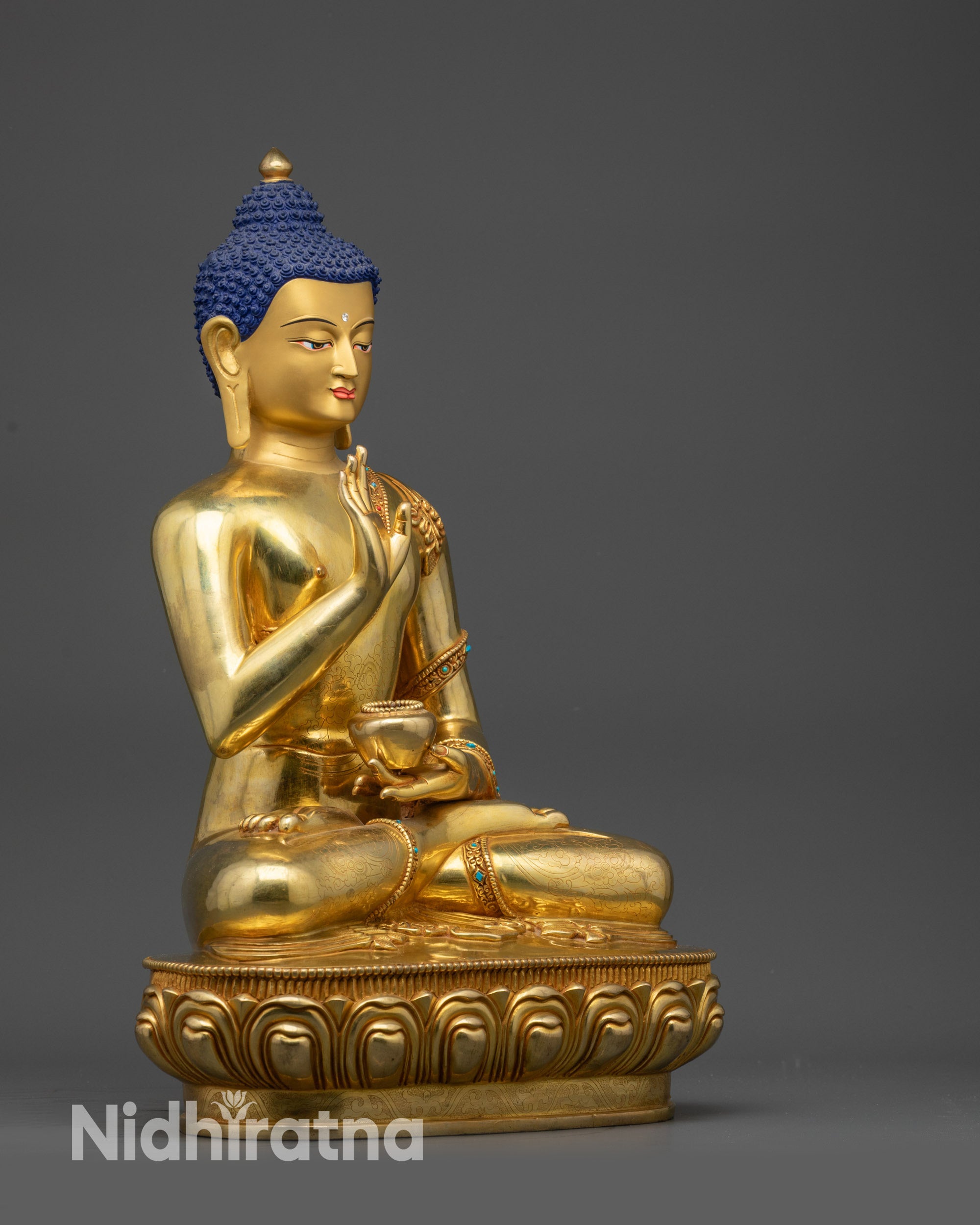 Side view of Amoghasiddhi Buddha statue holding bowl and showing abhaya mudra