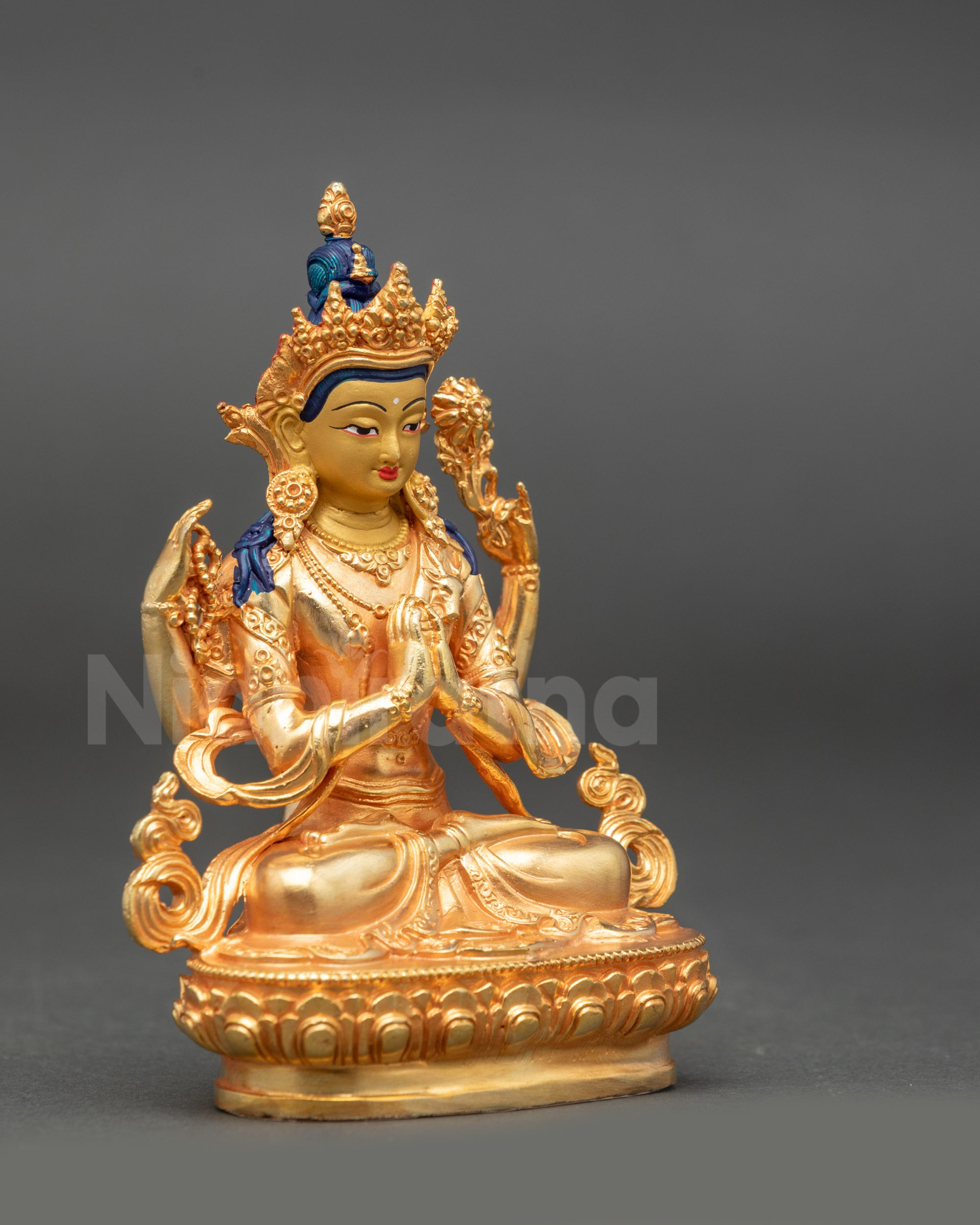 Side view of Chenrezig statue showing lotus, prayer rosary, and wish-fulfilling gem